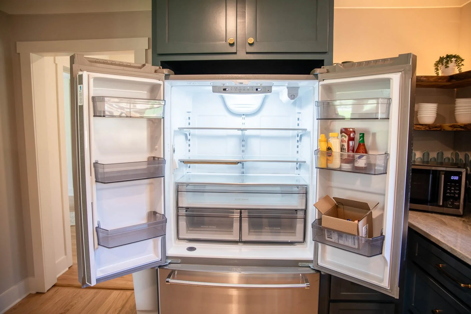 Clean ice and condiments waiting for you with ample space for groceries and a full size freezer. 