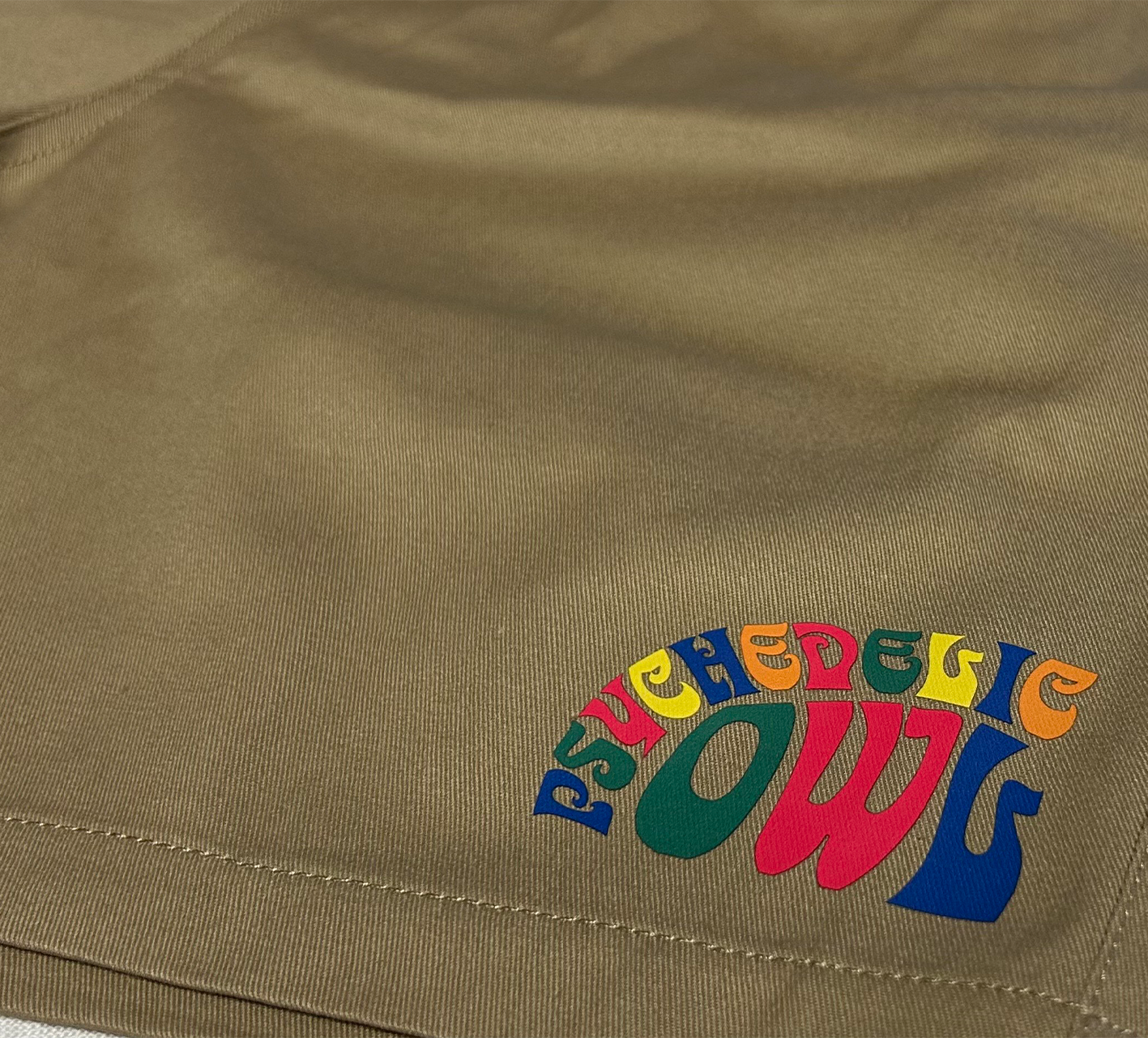 Khaki Psychedelic Owl shorts featuring a subtle logo on the front left side – comfortable and stylish for everyday wear or casual outings.
