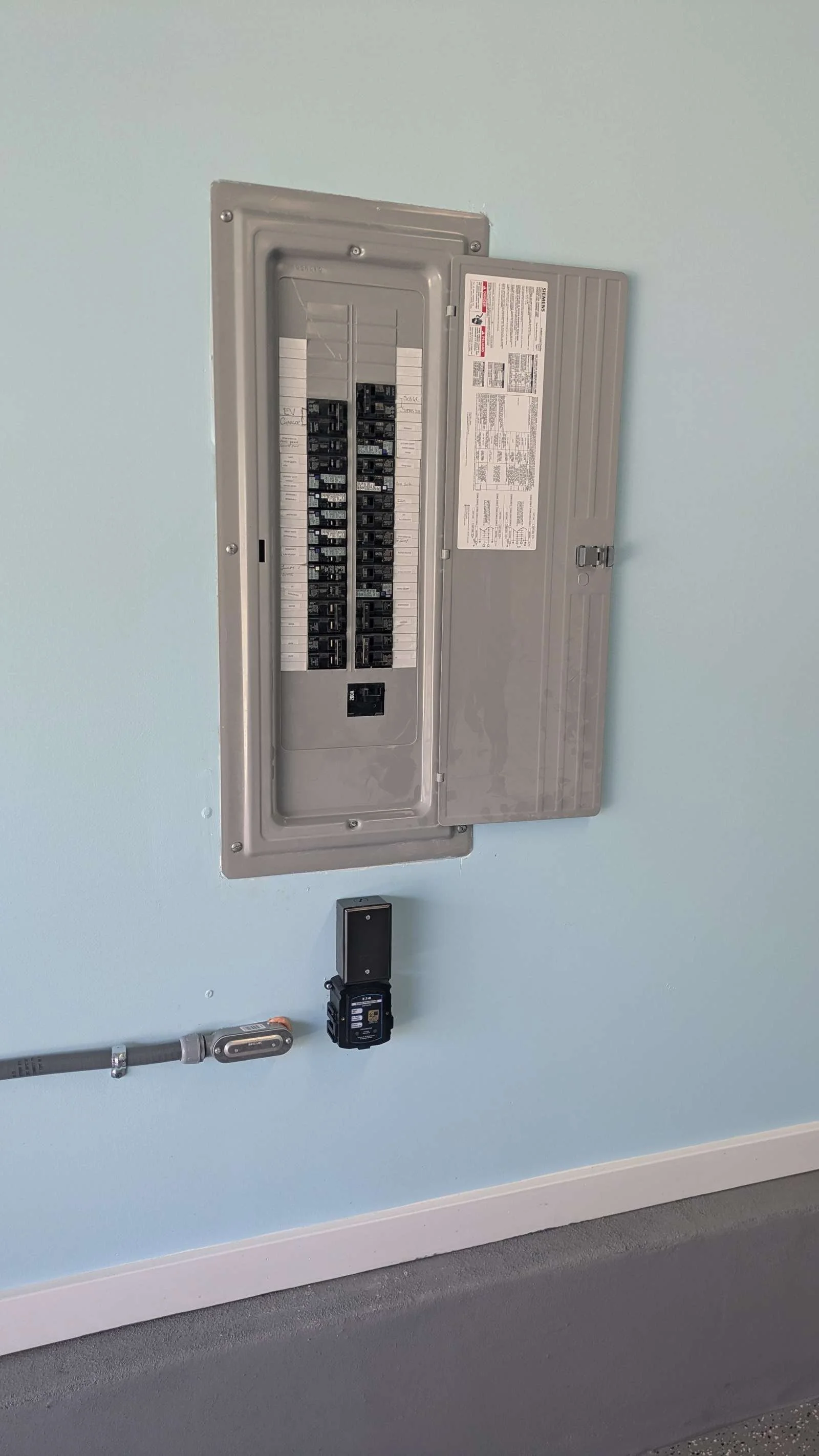 Surge Supppressor installed under electrical panel in garage in Holden Beach by WaveRider Electric & Automation