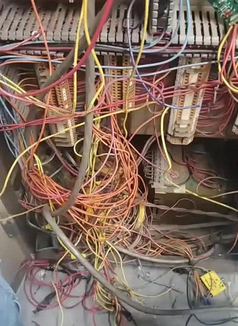 Wires hanging unorganized hazardous unsafe poor craftsmaship.