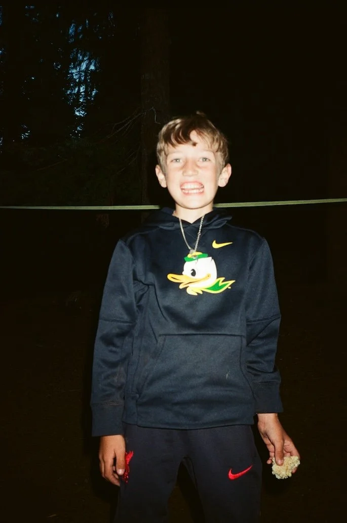 A kid camping at Suttle Lake Lodge in Central Oregon, surrounded by ponderosa pines near the Deschutes National Forest, enjoying outdoor adventures in Bend Oregon