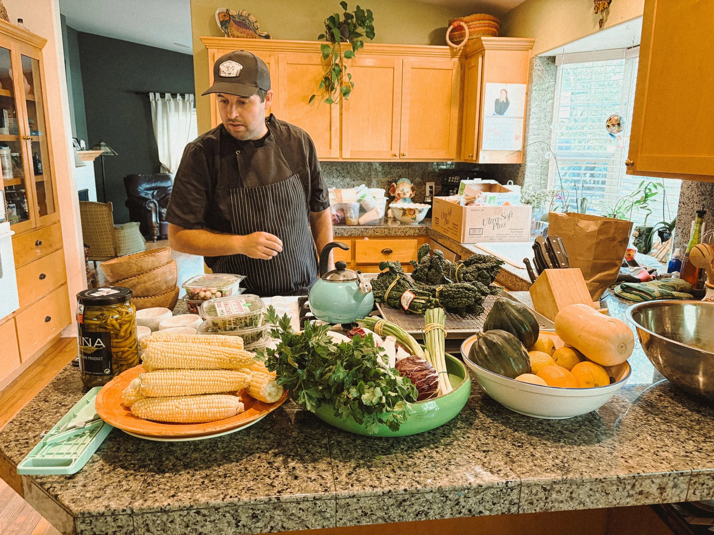 Chef Hector Boo Sanchez of Bos Taurus preparing farm-to-table vegetables for the Peace Bridges garden dinner at 425 NW State Street in Bend, Oregon