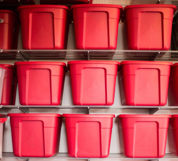 Red plastic totes on a shelving unit