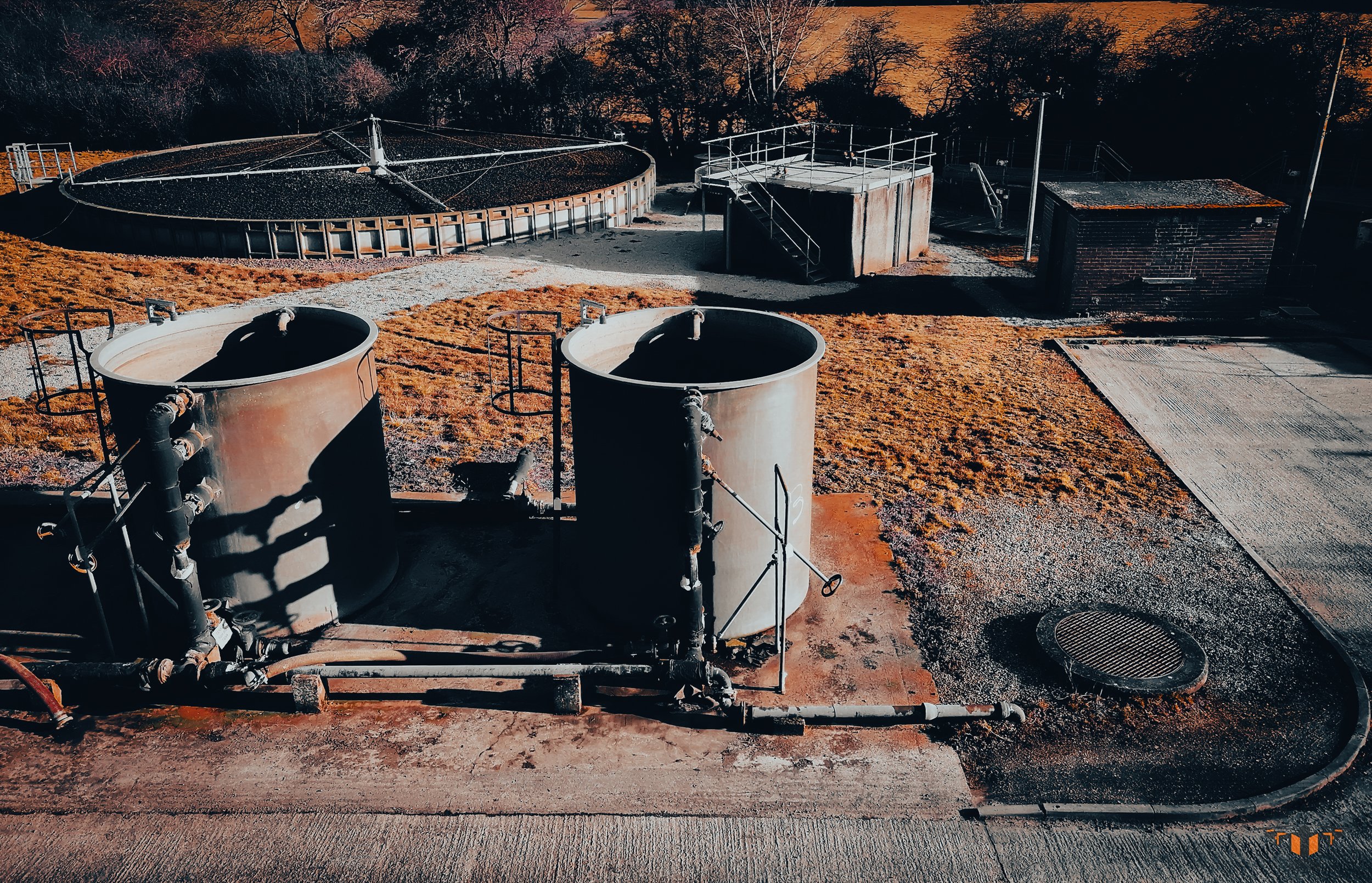 erial drone overview of water treatment facility showing tanks, pipework, settlement tank and site infrastructure — Airsuv ARC-structured infrastructure inspection data capture UK