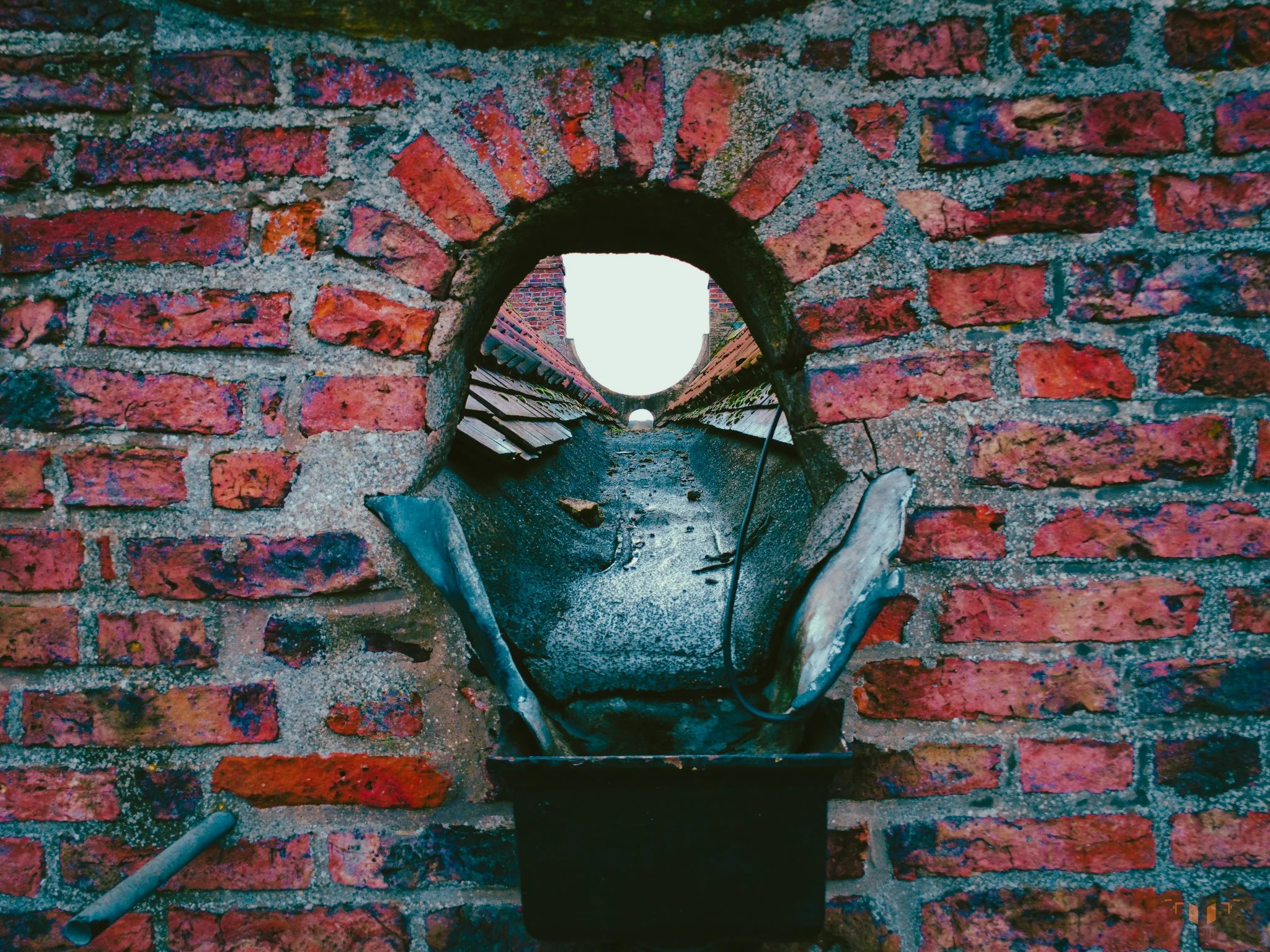 lose-range aerial drone capture of historic brick wall drainage outlet with lead flashing detail — Airsuv HEAG317-aligned non-contact heritage building condition survey