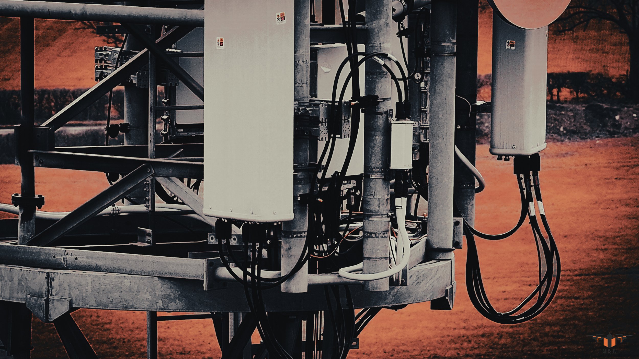 Close-range aerial drone inspection of cell tower RRU units, jumper connectors and feeder cable detail — Airsuv RF-aware ARC-structured antenna platform data capture