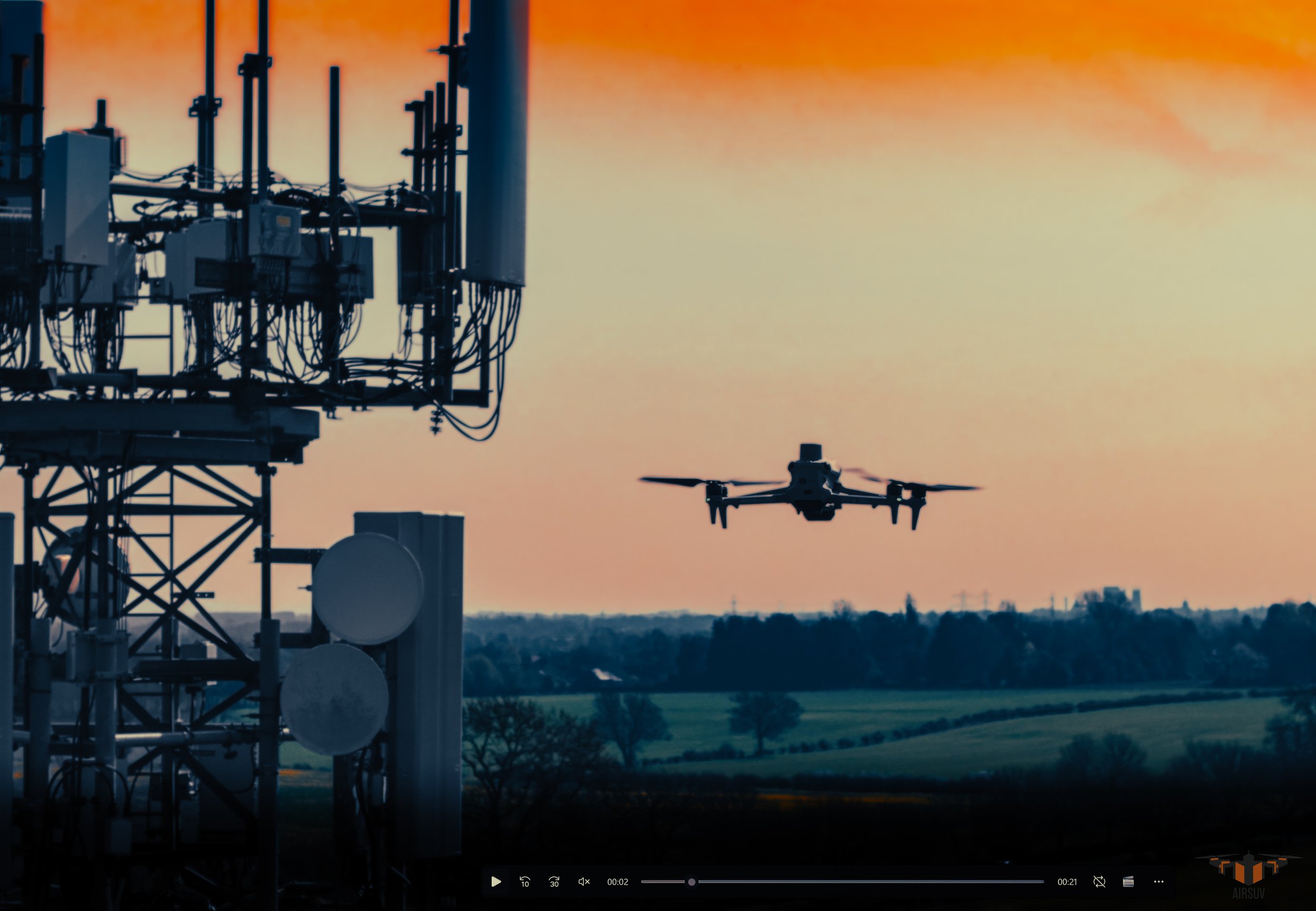 Enterprise drone in flight alongside cell tower antenna array at dusk — Airsuv RF-aware ARC-structured cell tower inspection data capture UK