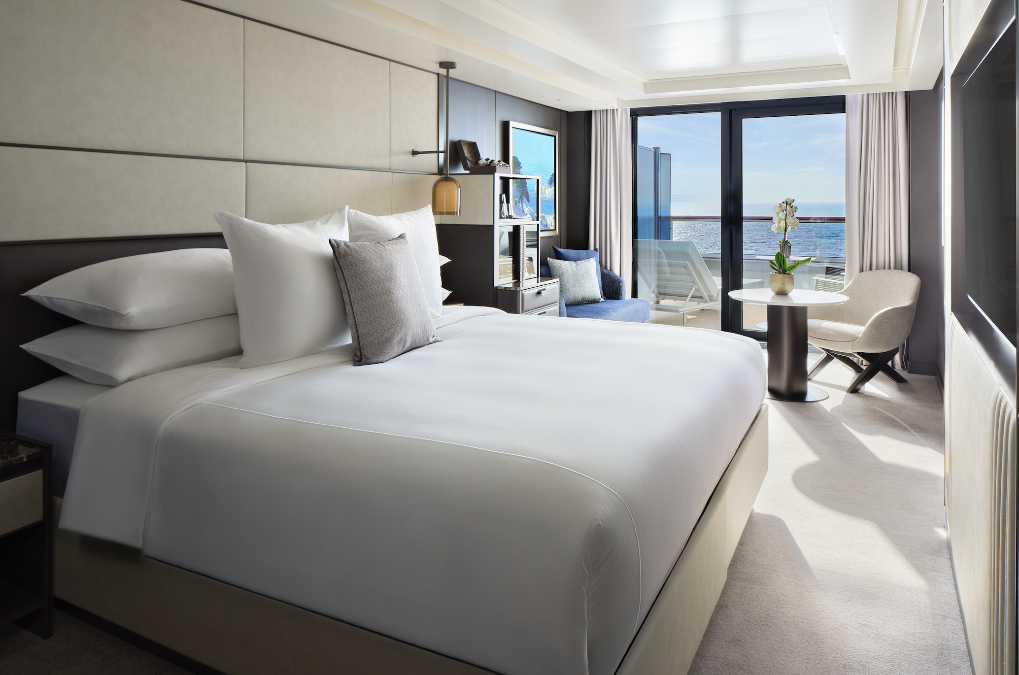 Luxury suite aboard The Ritz-Carlton Yacht Collection featuring a private balcony and ocean views.