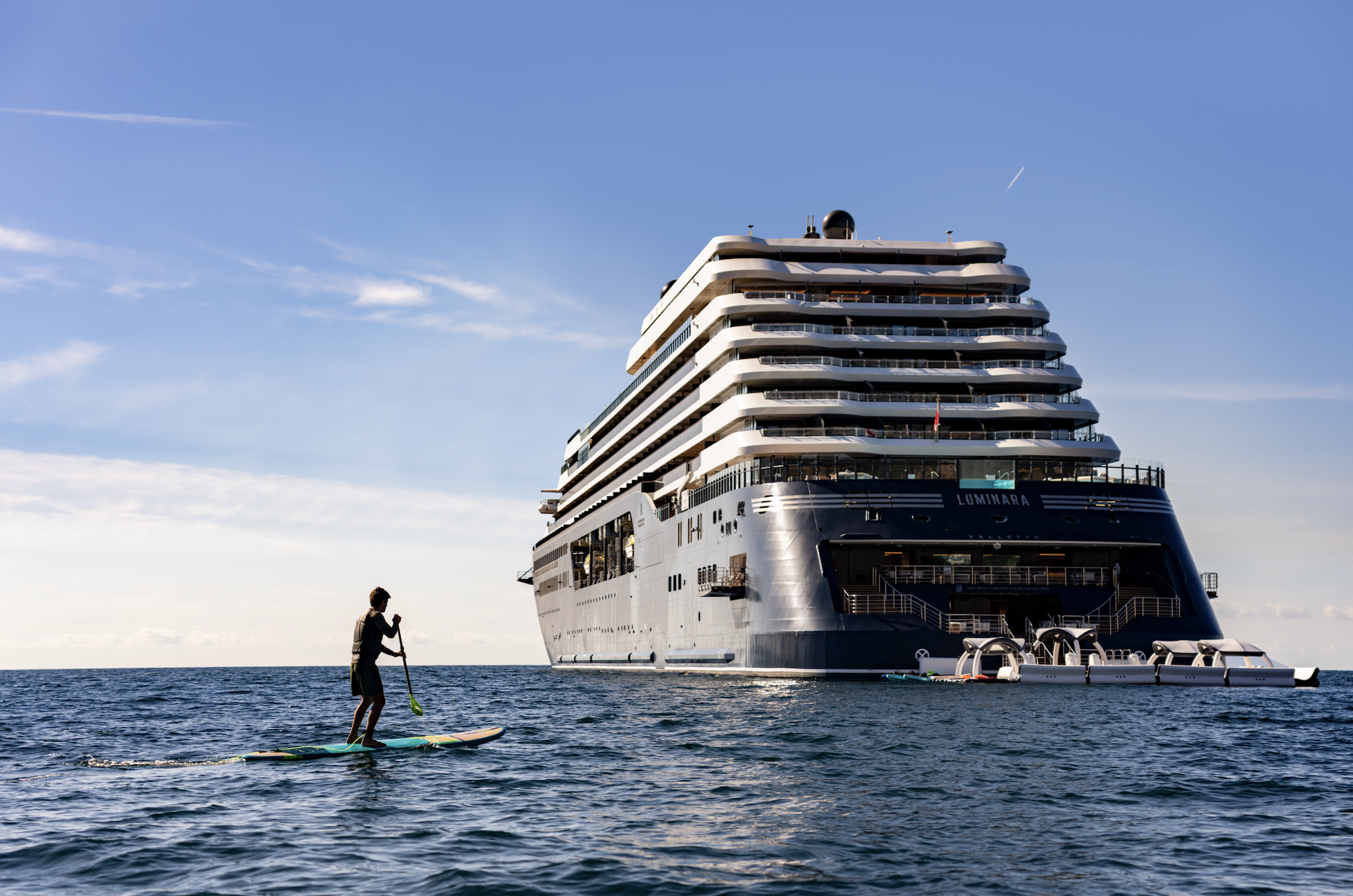 Ritz-Carlton Yacht Collection ship at sea with onboard marina and water sports, showcasing a luxury yachting experience.