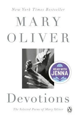Cover of the book 'Devotions' by Mary Oliver. It features a black and white photograph of hands and a paintbrush, with text indicating it's a New York Times Bestseller and includes a 'Read With Jenna' sticker.
