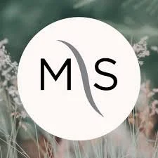 Logo with letters M and S divided by a curved line, on a blurred nature background.