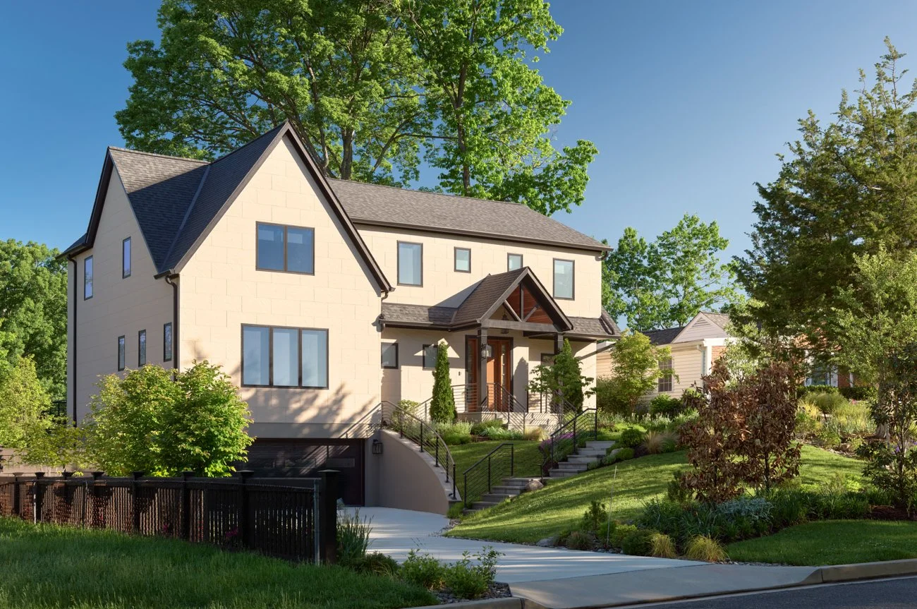A modern multi-story house with a landscaped front yard, trees, and a concrete walkway leading to the entrance, with a clear blue sky above.