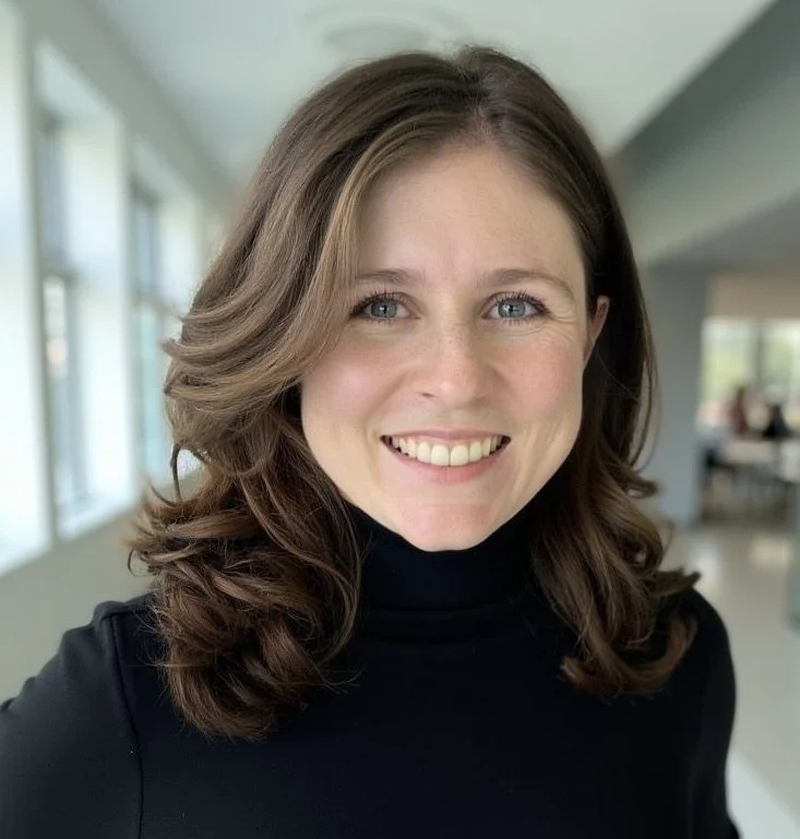 A close up profile of a professional woman smiling in a corporate setting