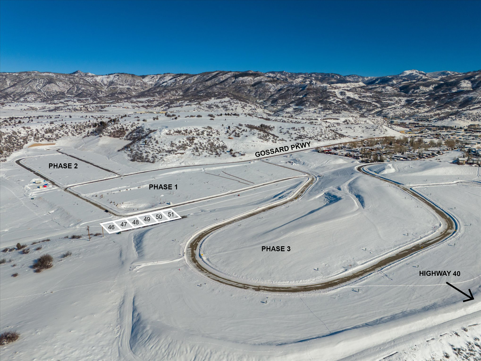 Aerial view of snowy landscape with marked phases and roads, including Gossard Parkway and Highway 40, showcasing a development site divided into phases 1, 2, and 3 with numbered plots.
