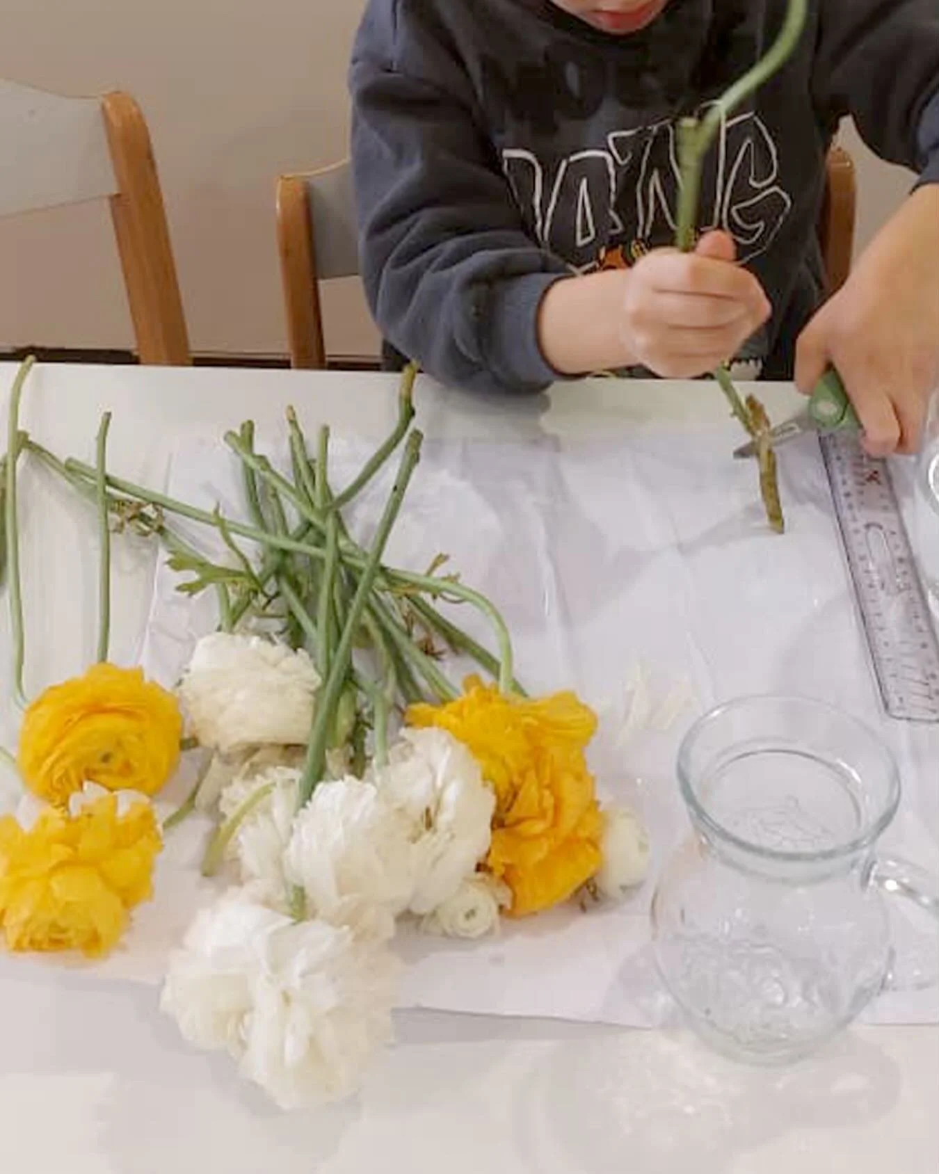 Flower arranging may seem like a simple task, but it allows children to practice everyday skills such as pouring, cutting, measuring, estimating, and arranging. It also helps them to feel a sense of pride when they see something they chose, prepared,