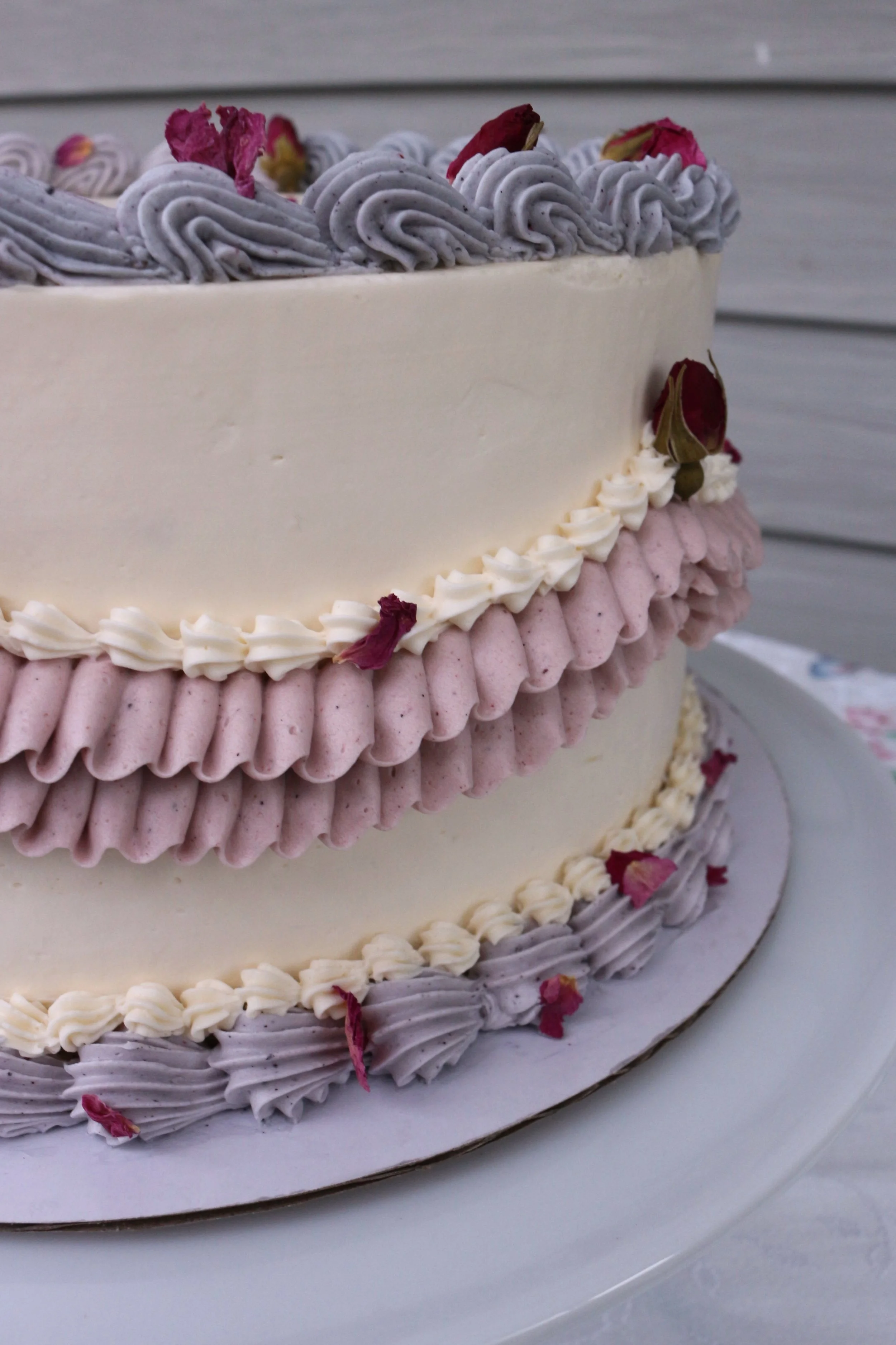 Made locally in Elgin, IL by Cakes by Caroline, this vanilla cake is decorated with vanilla Swiss meringue buttercream vintage piping.