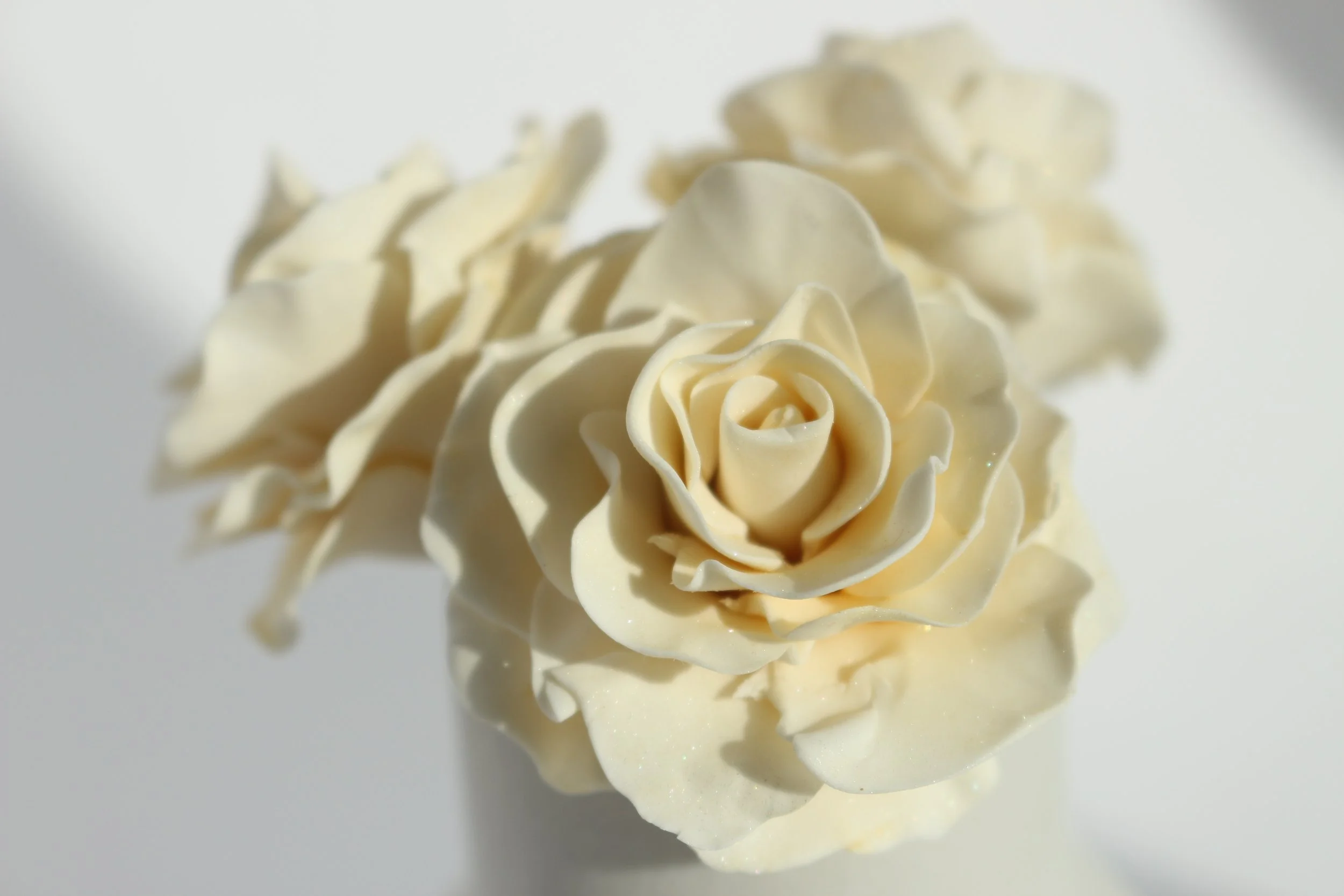 White gum paste flowers with edible shimmer.