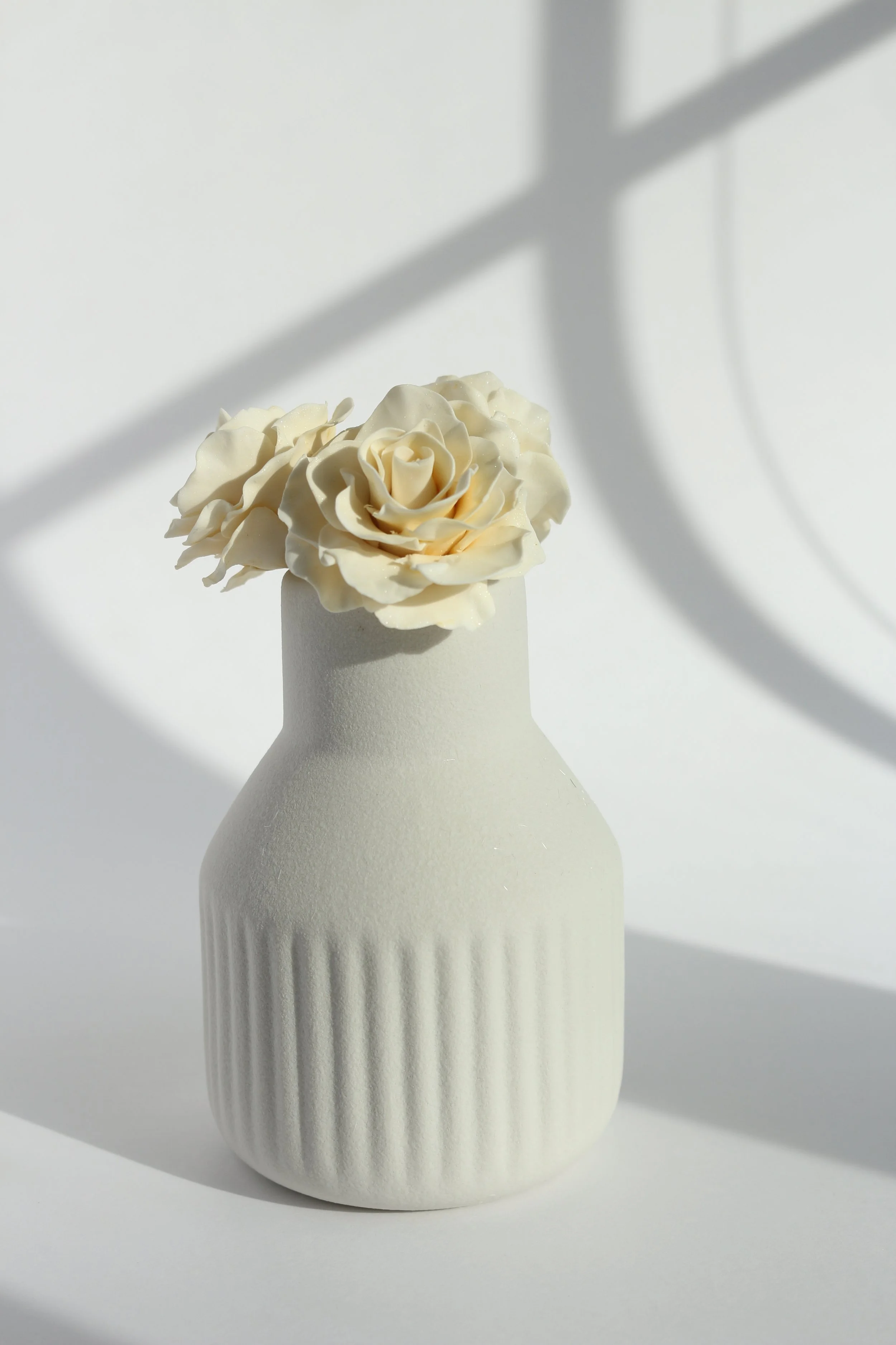 White gum paste flowers with edible shimmer.