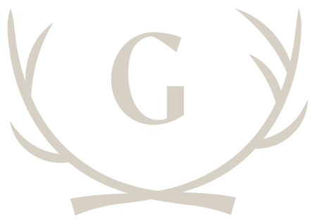 A stylized letter G inside a circular emblem with decorative antler-like branches, in a light beige color.