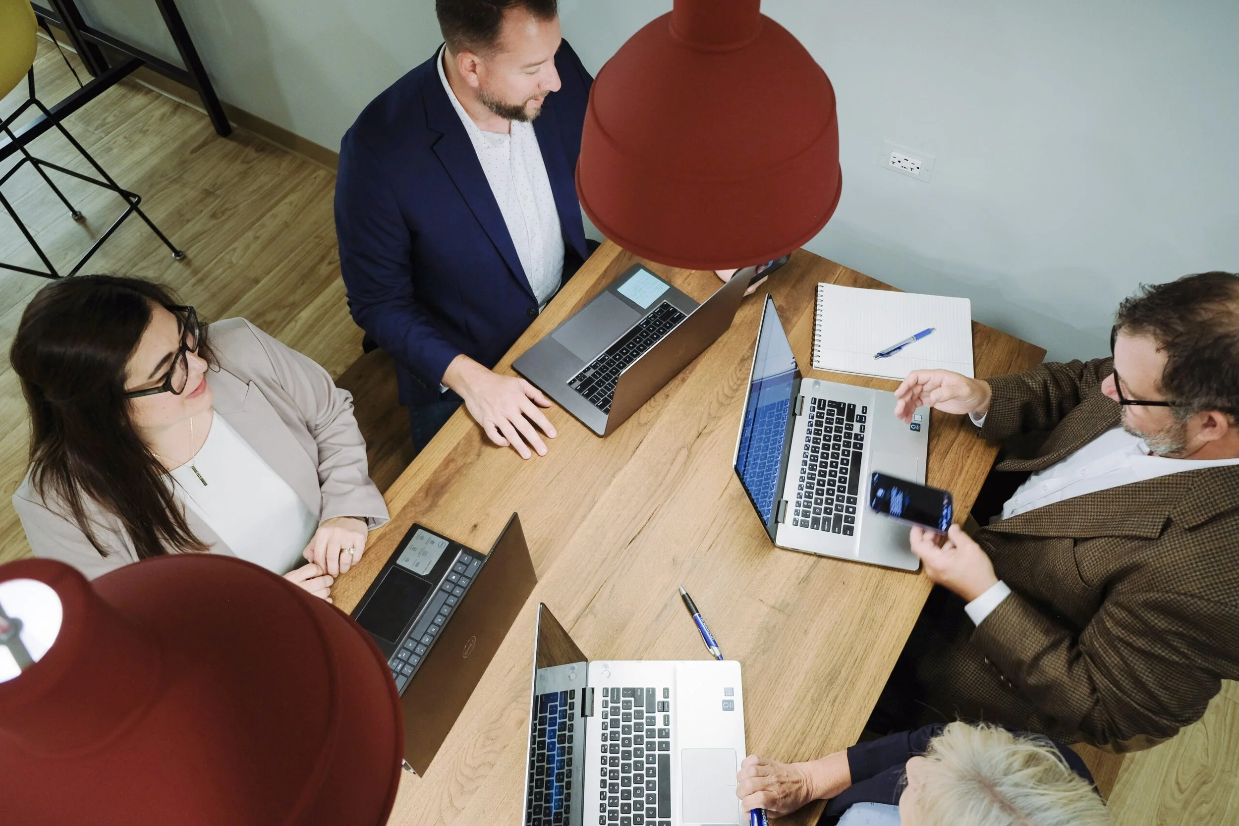 An overhead view of the Thornwood Financial team working together around a table.