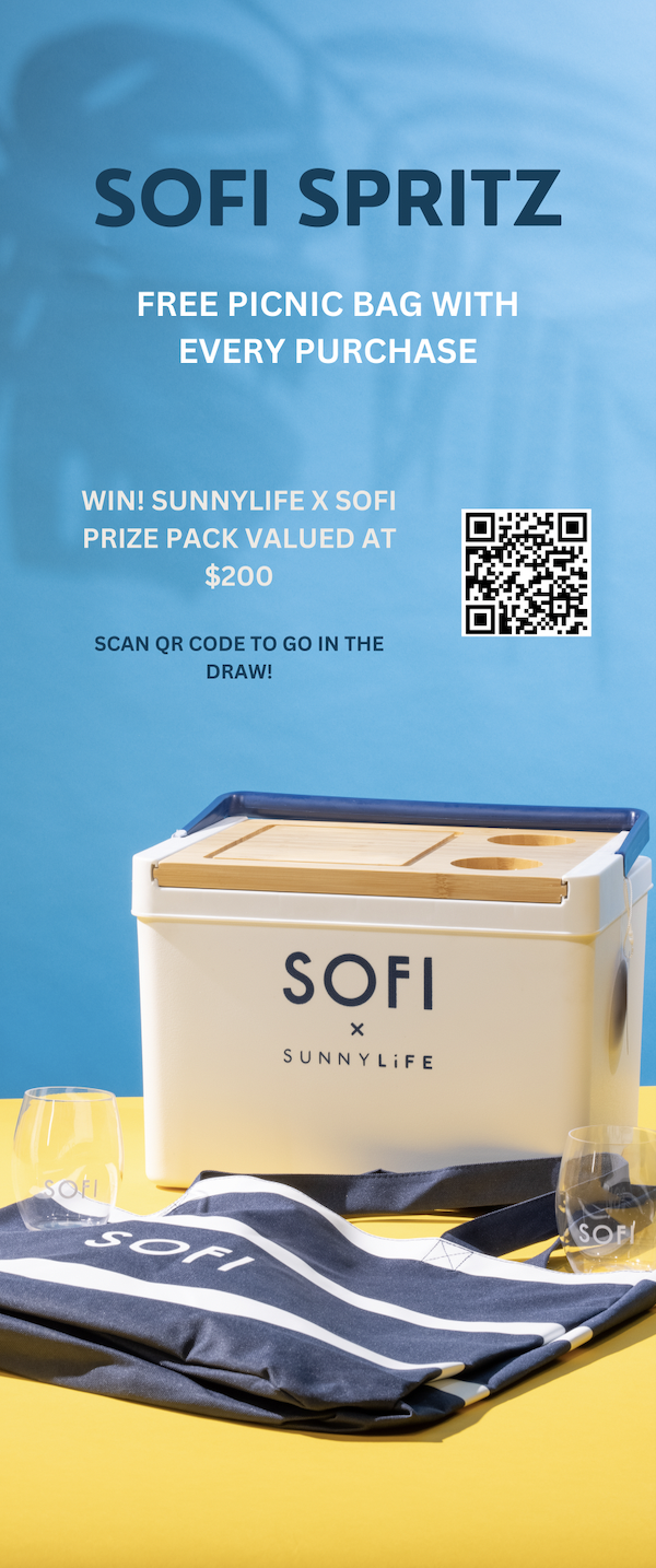 A promotional display for SOFI Spritz, offering a free picnic bag with every purchase, with a QR code for entering a contest, and a SOFI-branded cooler, glasses, and tote bag on a yellow surface.