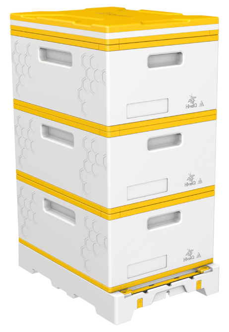 Three stacked white honeybee hive boxes with yellow trim on a white base.