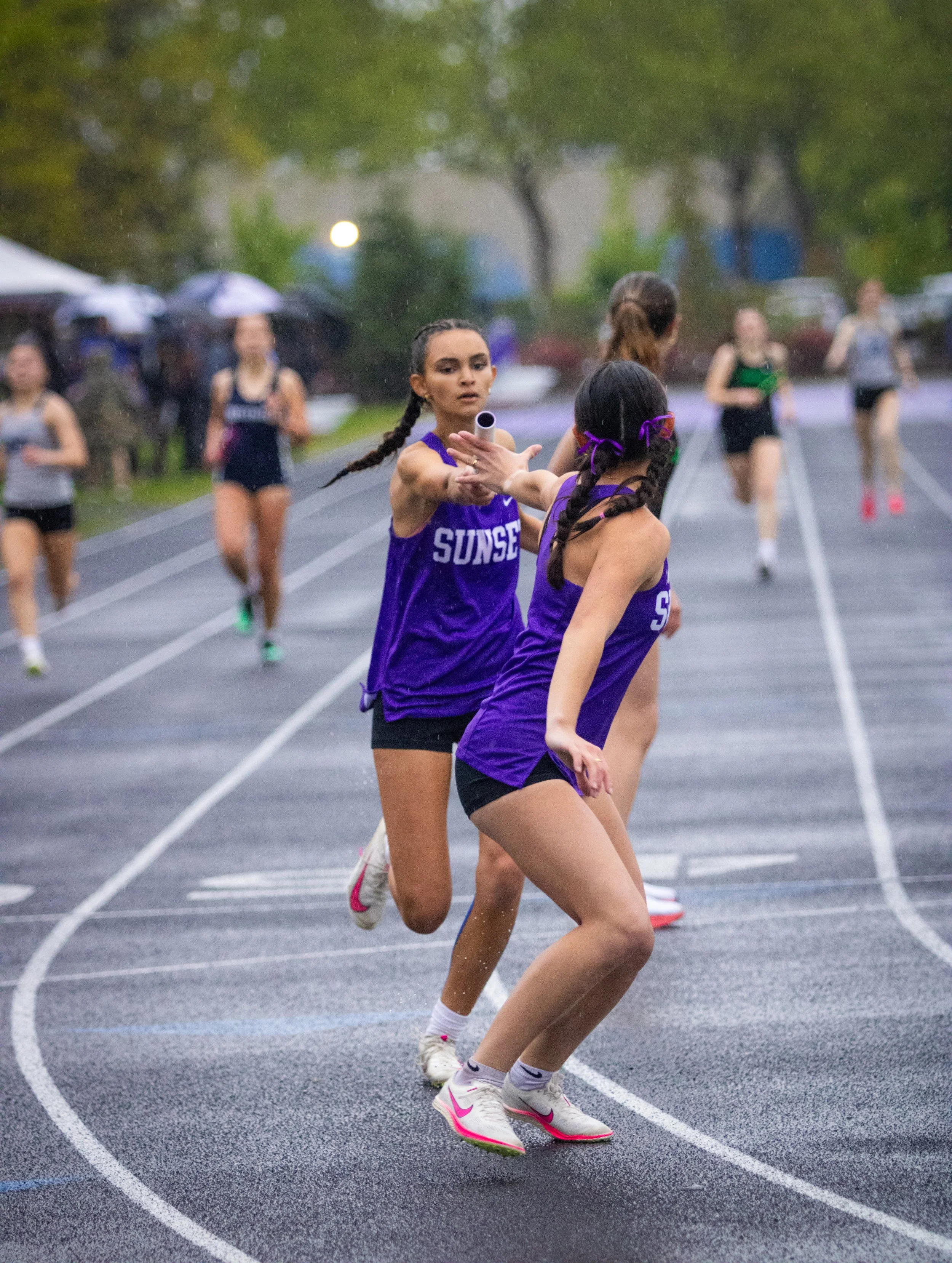 handing-off-the-baton-in-track-relay.JPG