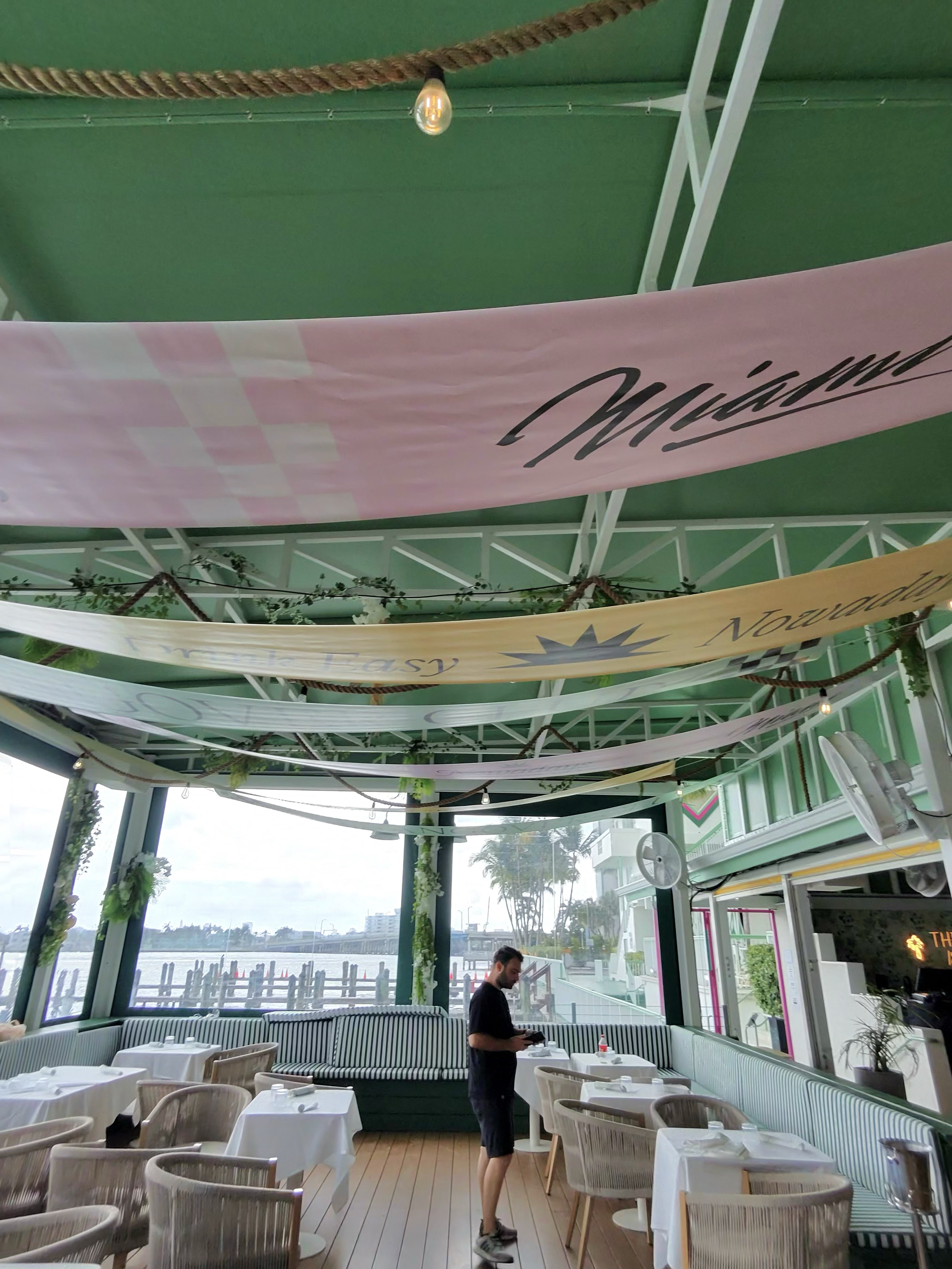 Covered waterfront hospitality area at Palm Tree Club