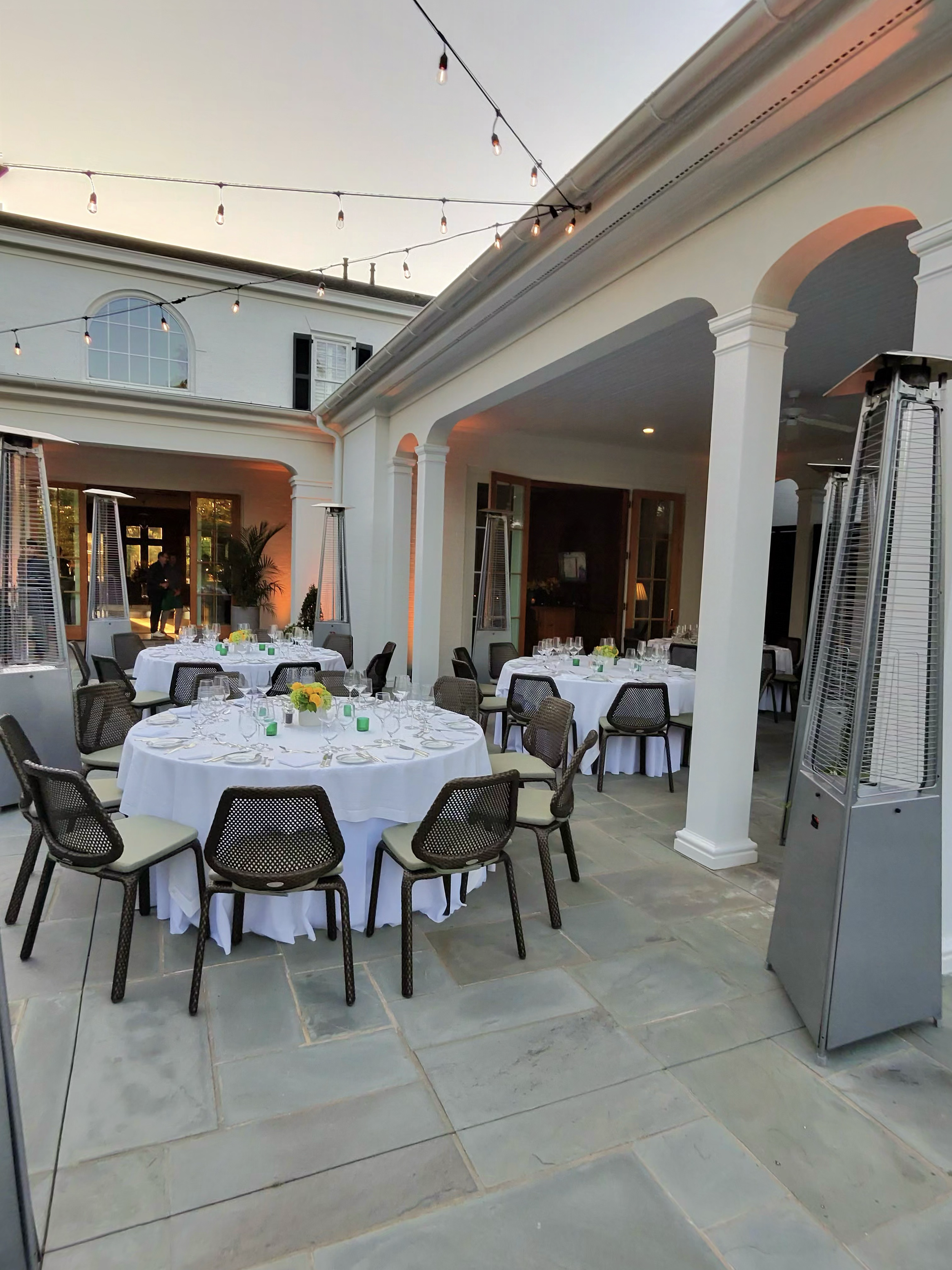 Covered patio dining setup for Rolex guests during The Masters