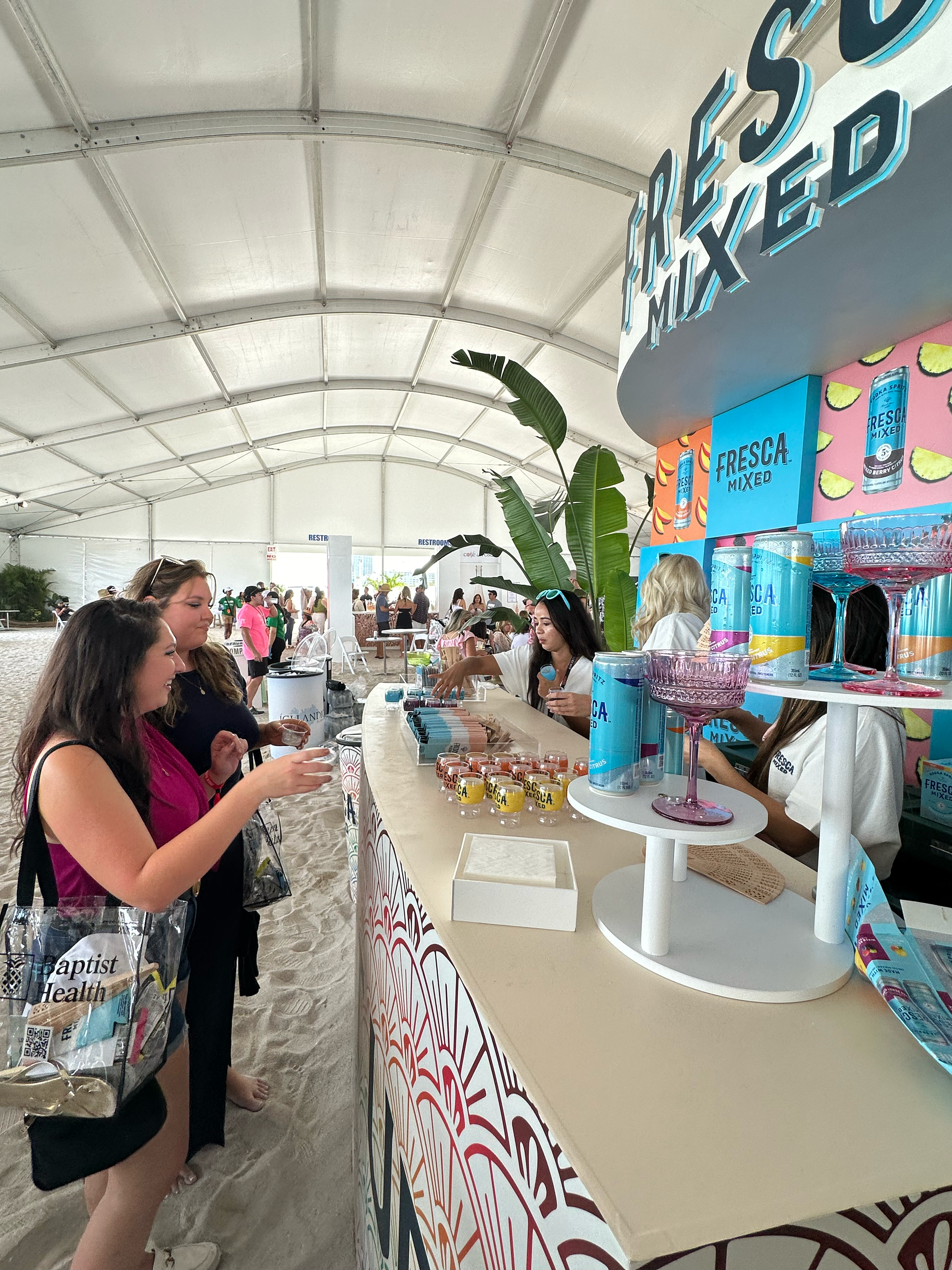 Festival guests sampling Fresca Mixed drinks inside the event tent