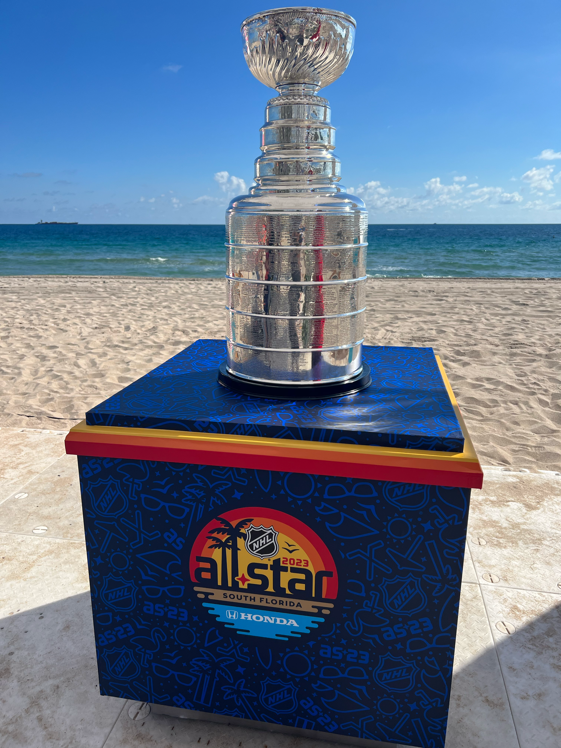 Stanley Cup displayed on an NHL All-Star pedestal on Fort Lauderdale Beach.