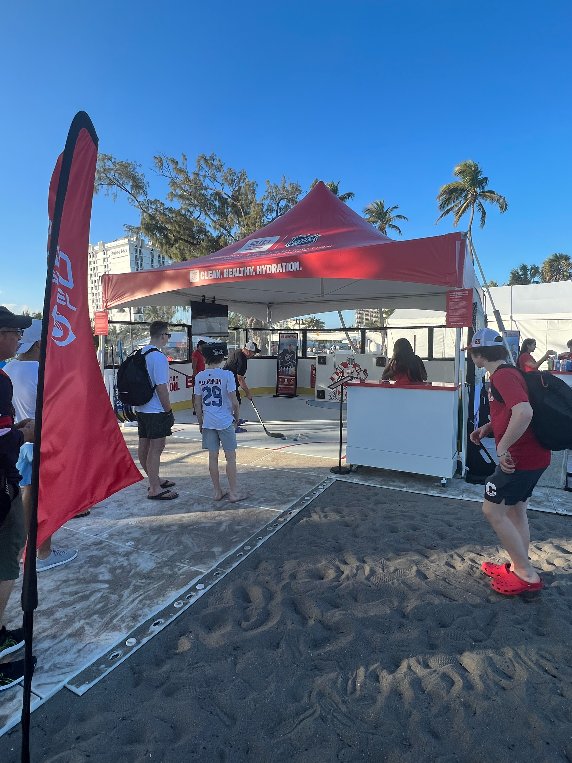 BioSteel outdoor sampling tent with branded counters and flags at an NHL fan event.