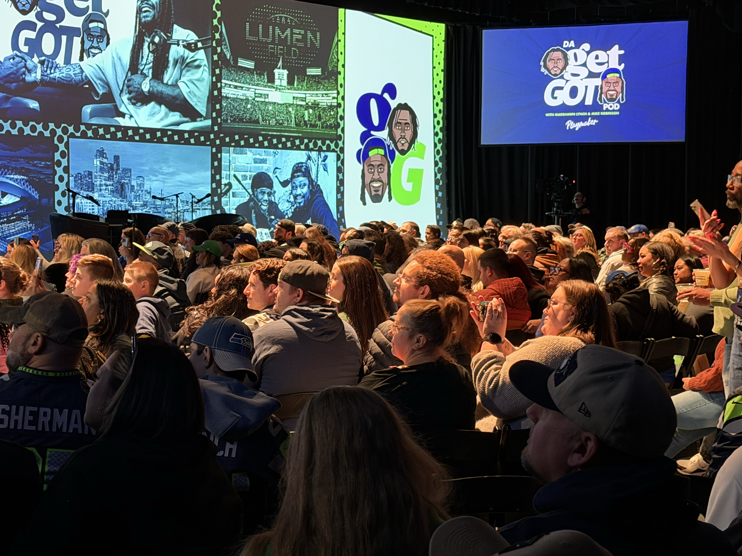 Audience watching Da Get Got live podcast onstage in Seattle
