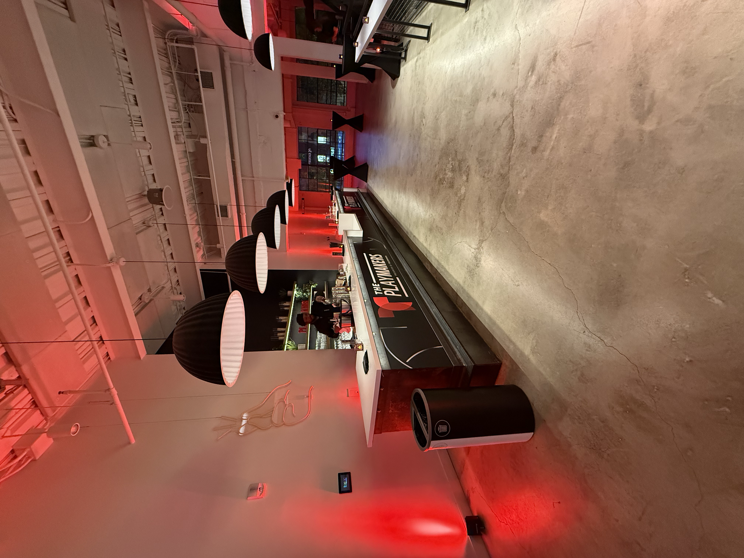 Red-lit entrance area for The Playmakers event