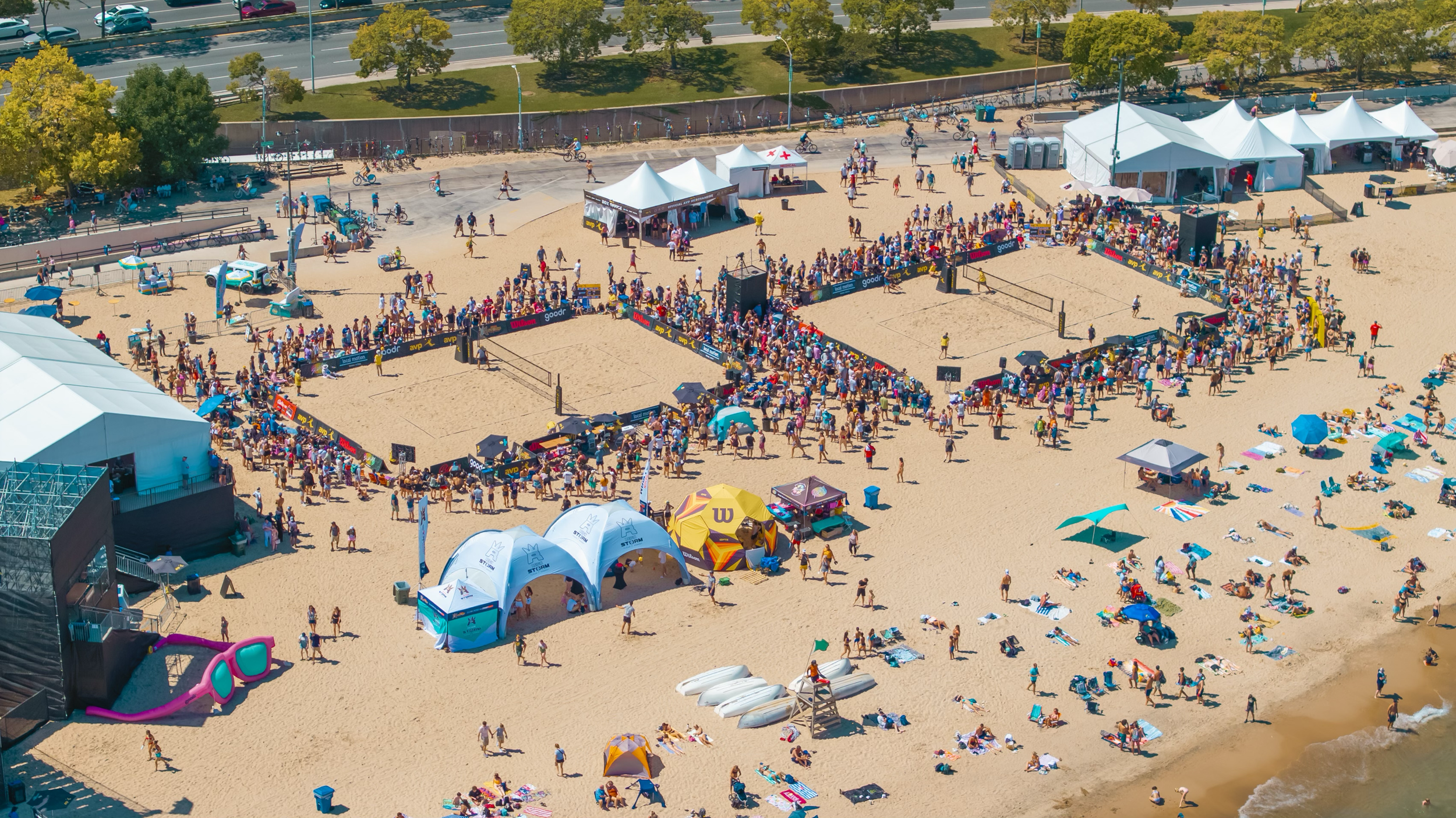 Overhead view of AVP beach volleyball courts and surrounding spectators
