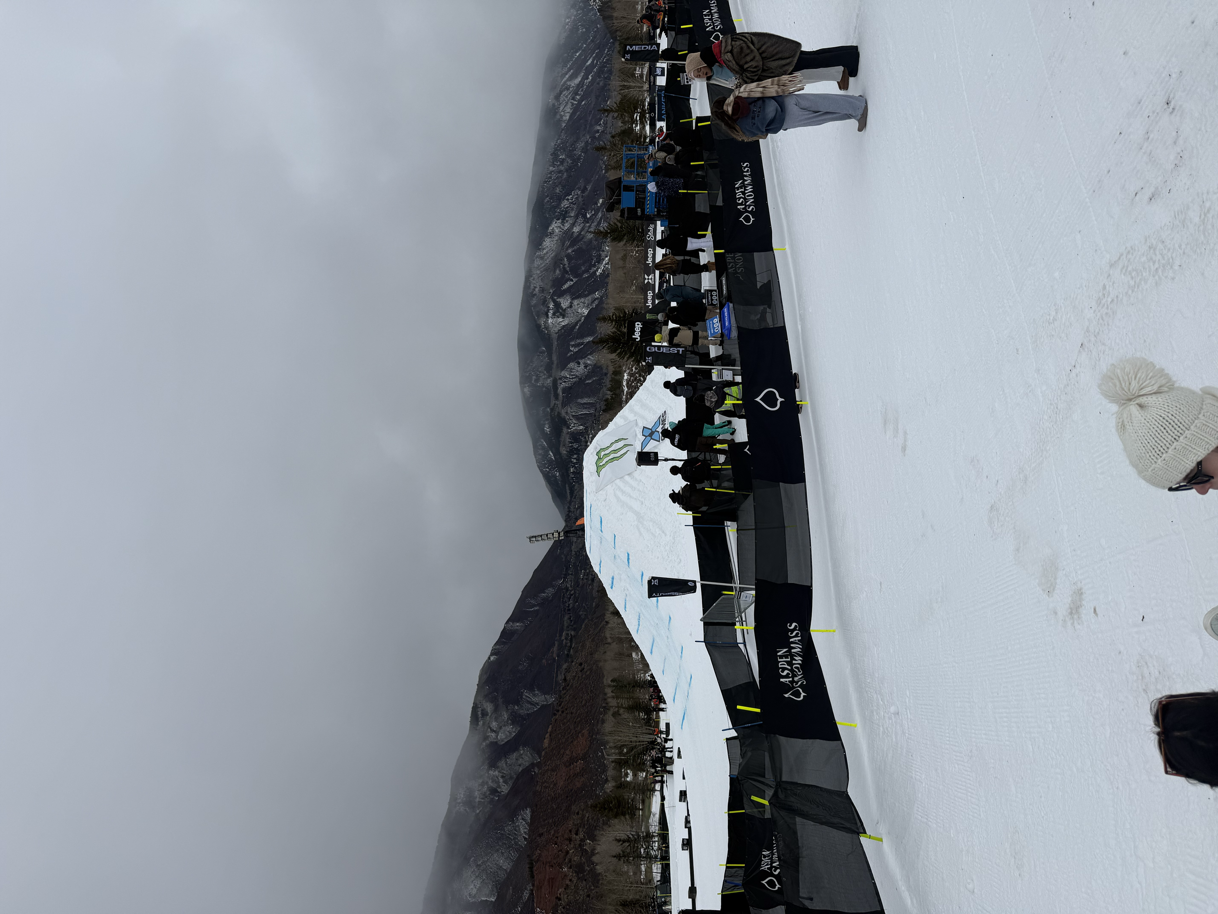 Snow-covered X Games venue with event tents and spectators in Aspen