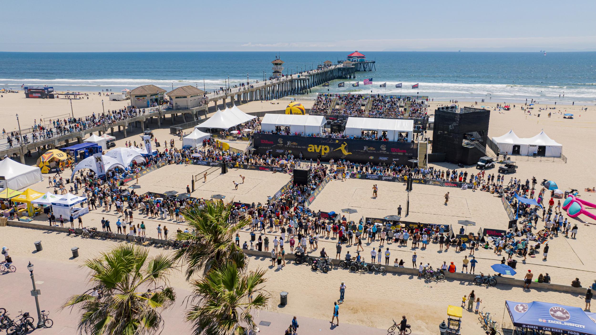Wide view of the AVP event courts, grandstands, and Huntington Beach pier