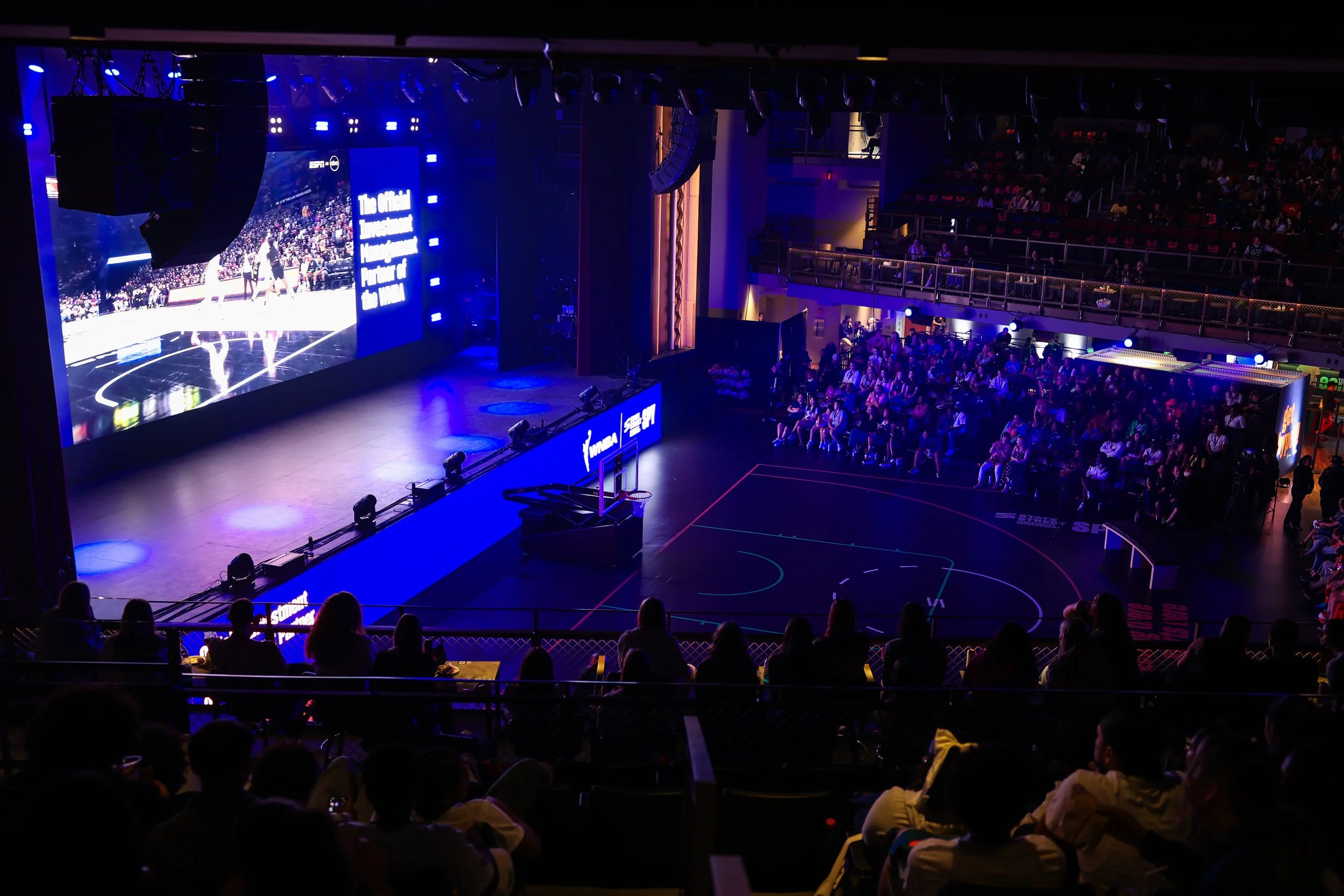 Audience seating and illuminated basketball event floor