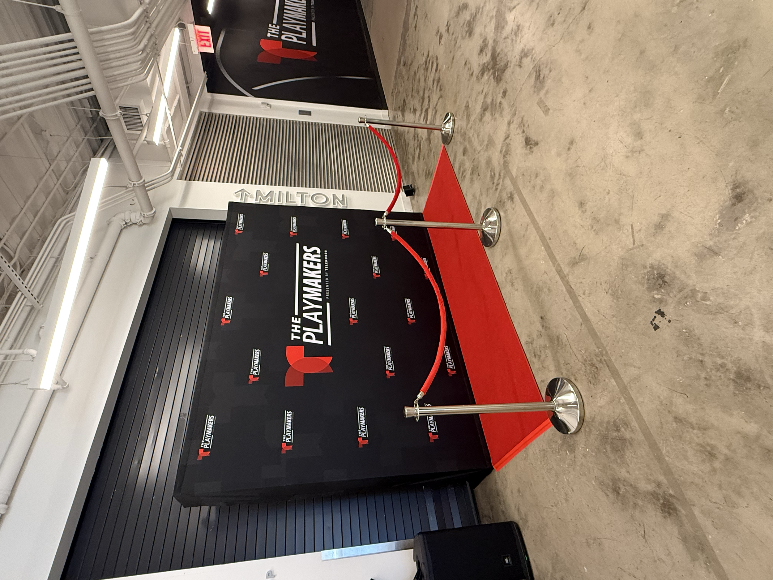 Branded photo backdrop with red carpet and stanchions