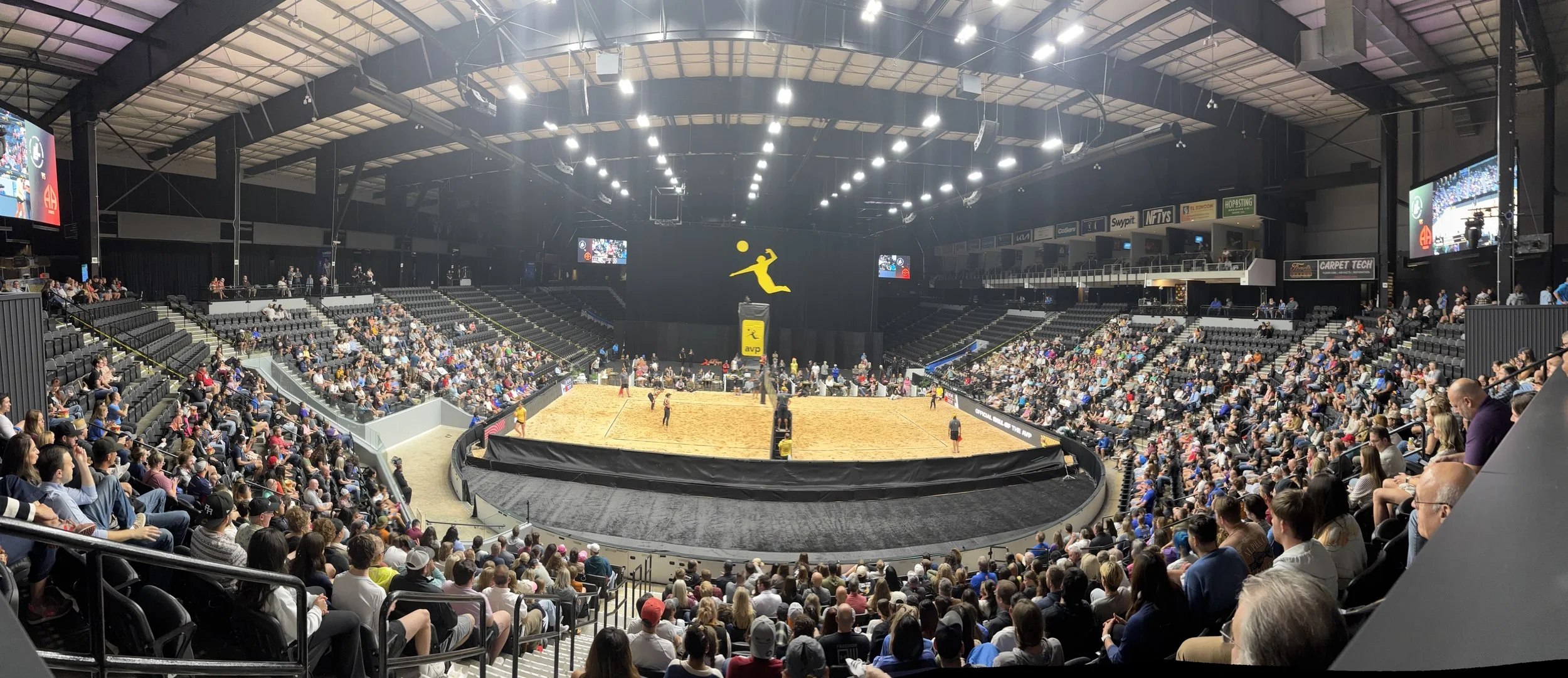 Spectators watching an AVP match inside an arena