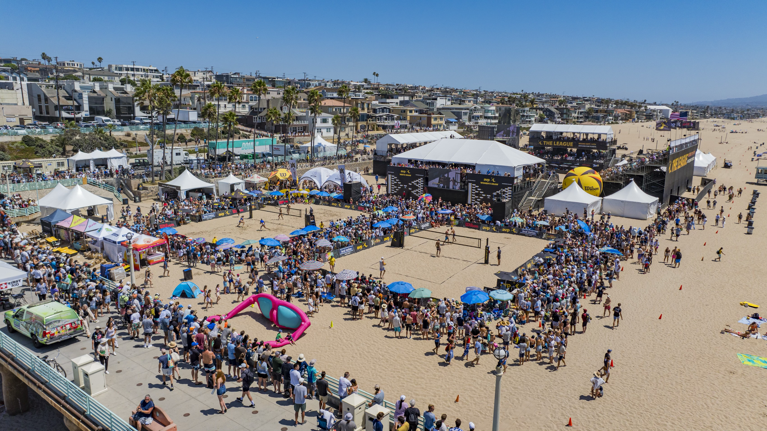 Spectators surrounding the AVP courts and sponsor activations