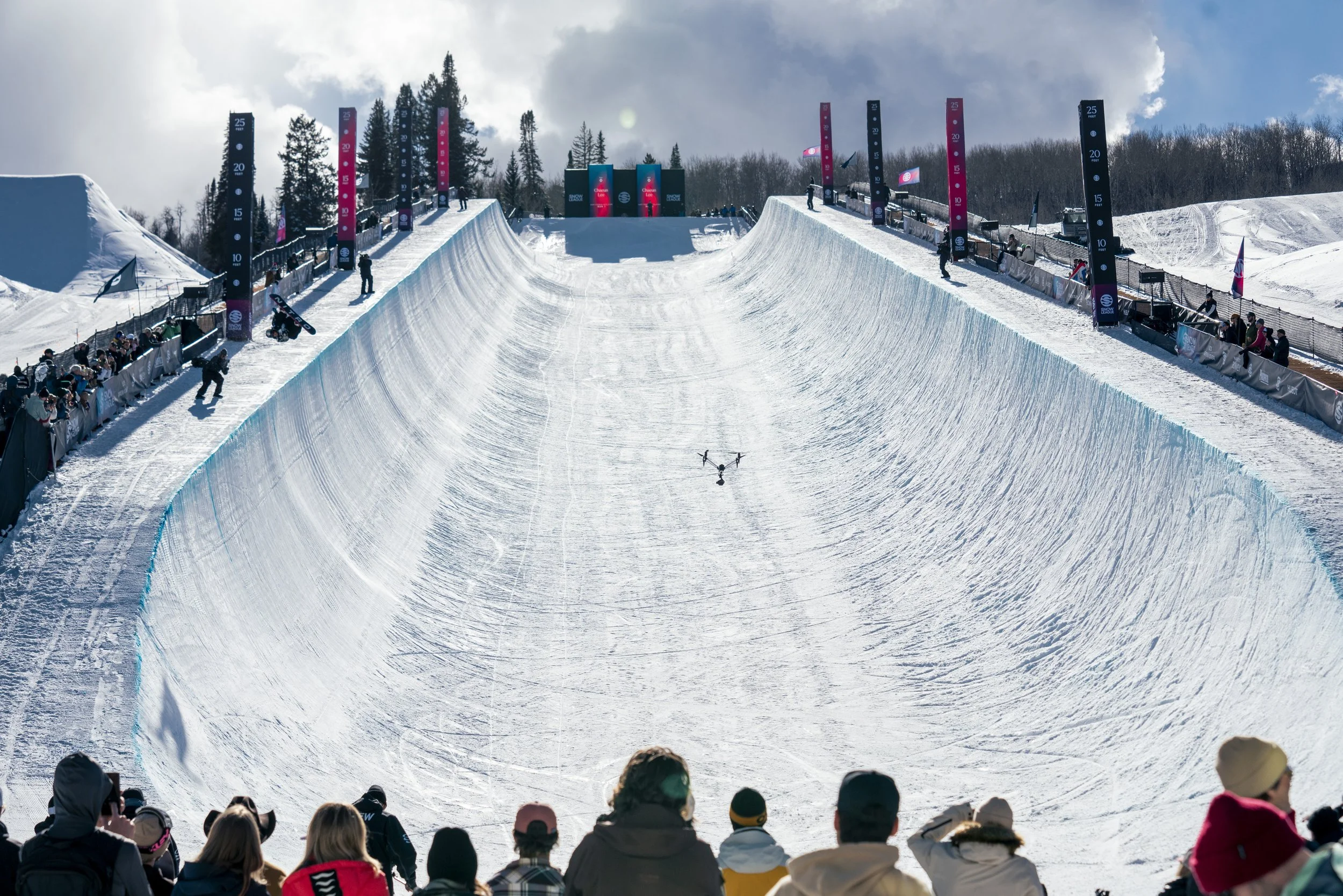 Snow League superpipe with spectators at its base