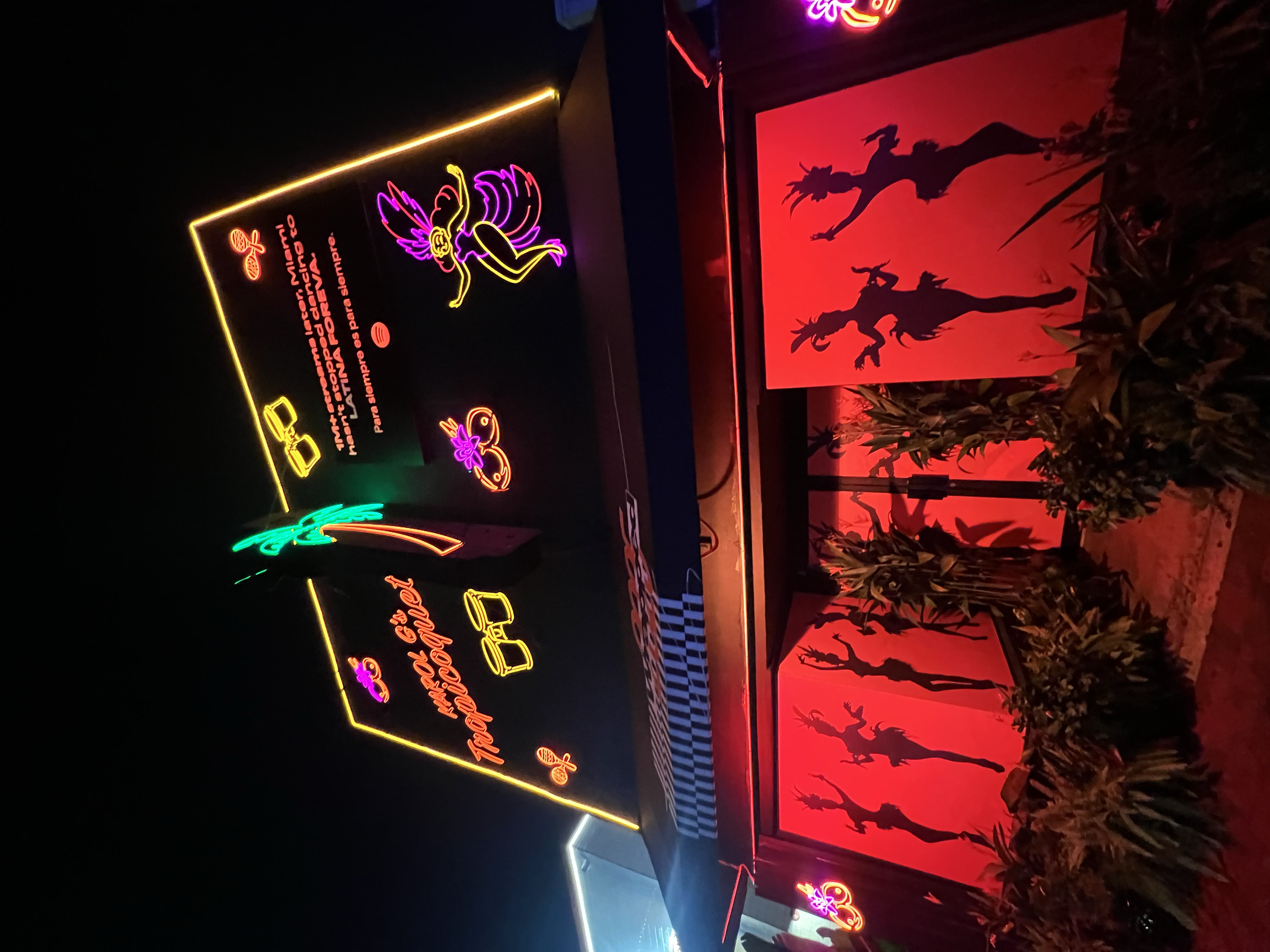 Illuminated Karol G activation signage at night