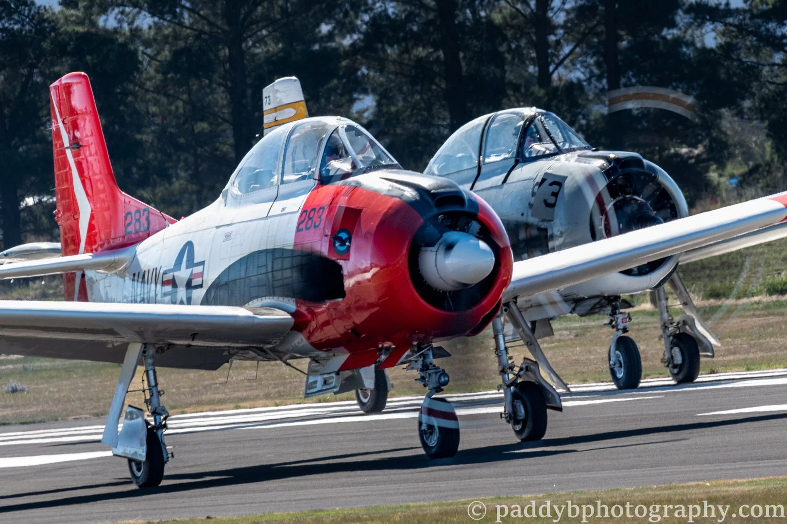 Two North American T-28 Trojan's get ready to launch to provide an emotional display celebrating the recently passed T-28 pilot Brett Emeny at Warbirds over Wanaka 2024