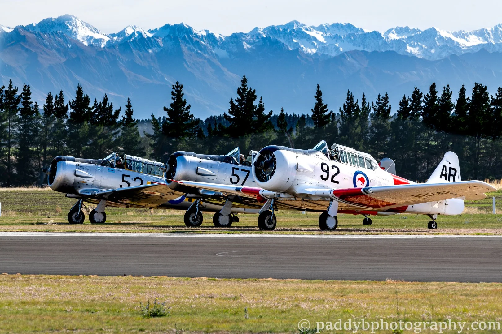 Three of the display team the "Roaring Forties" waiting in front of the Southern Alps at Warbirds over Wanaka 2024 