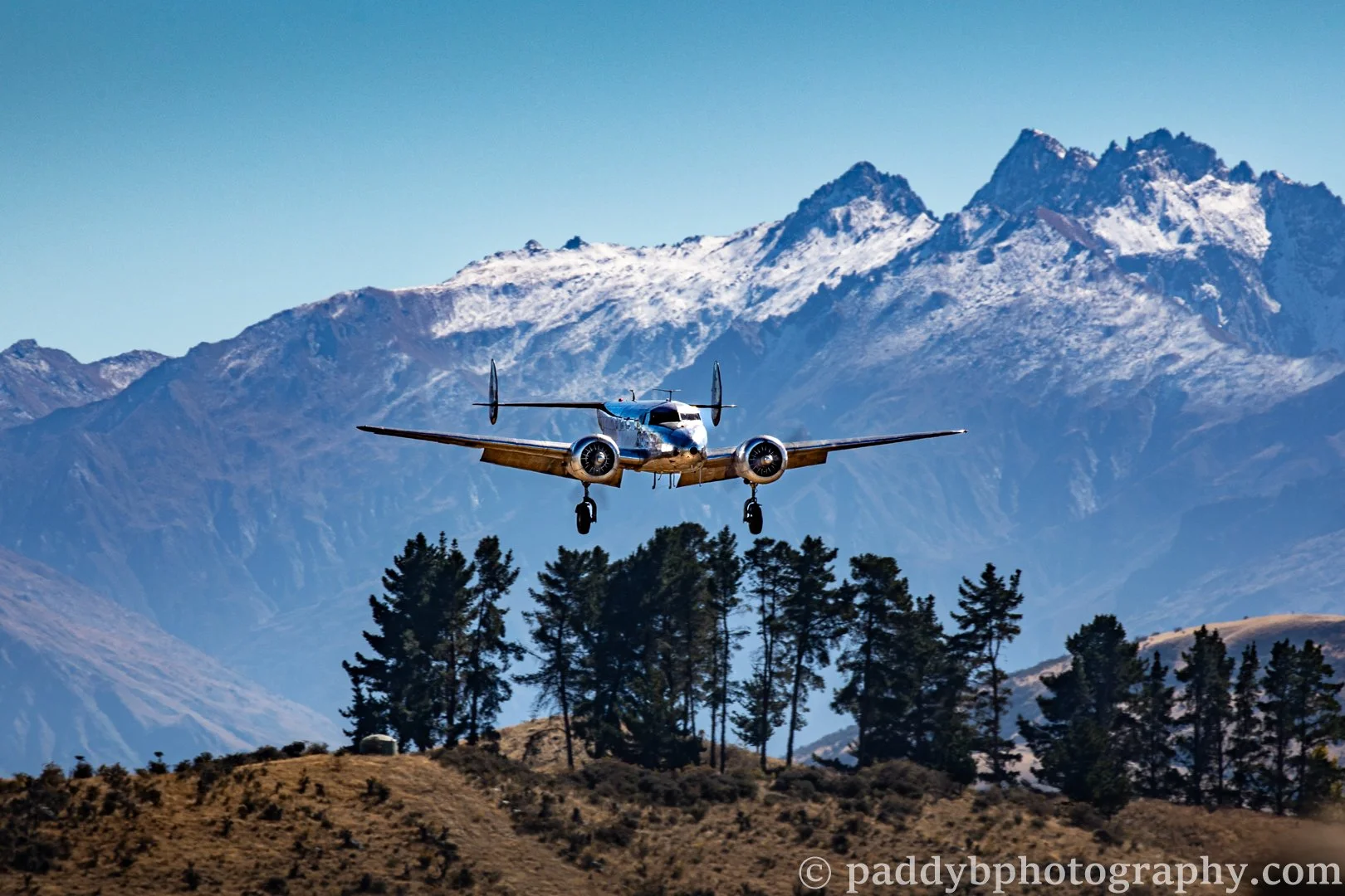 The Lockheed Model 10 Electra coming in to land in front of the Southern Alps at Warbirds over Wanaka 2024