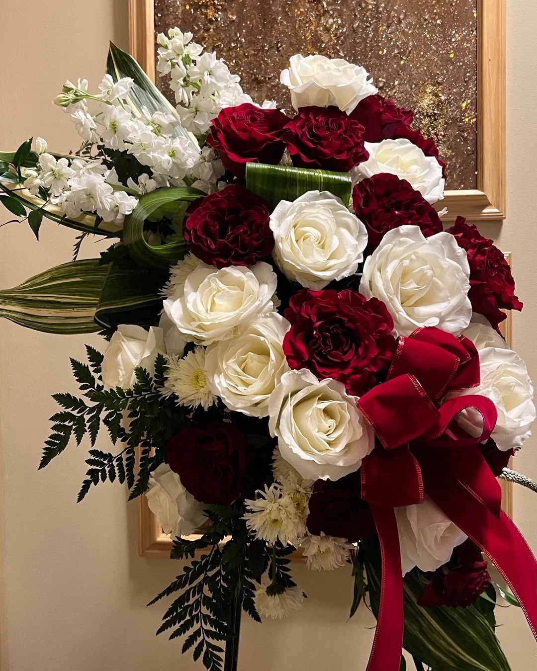 Request: Simple-Demure and Understated, Pretty. Only Red and White Roses a few Sprinkles of Fillers. &ldquo;That&rsquo;s how she lived her life, elegant, quite, no frills, and pretty!&rdquo;