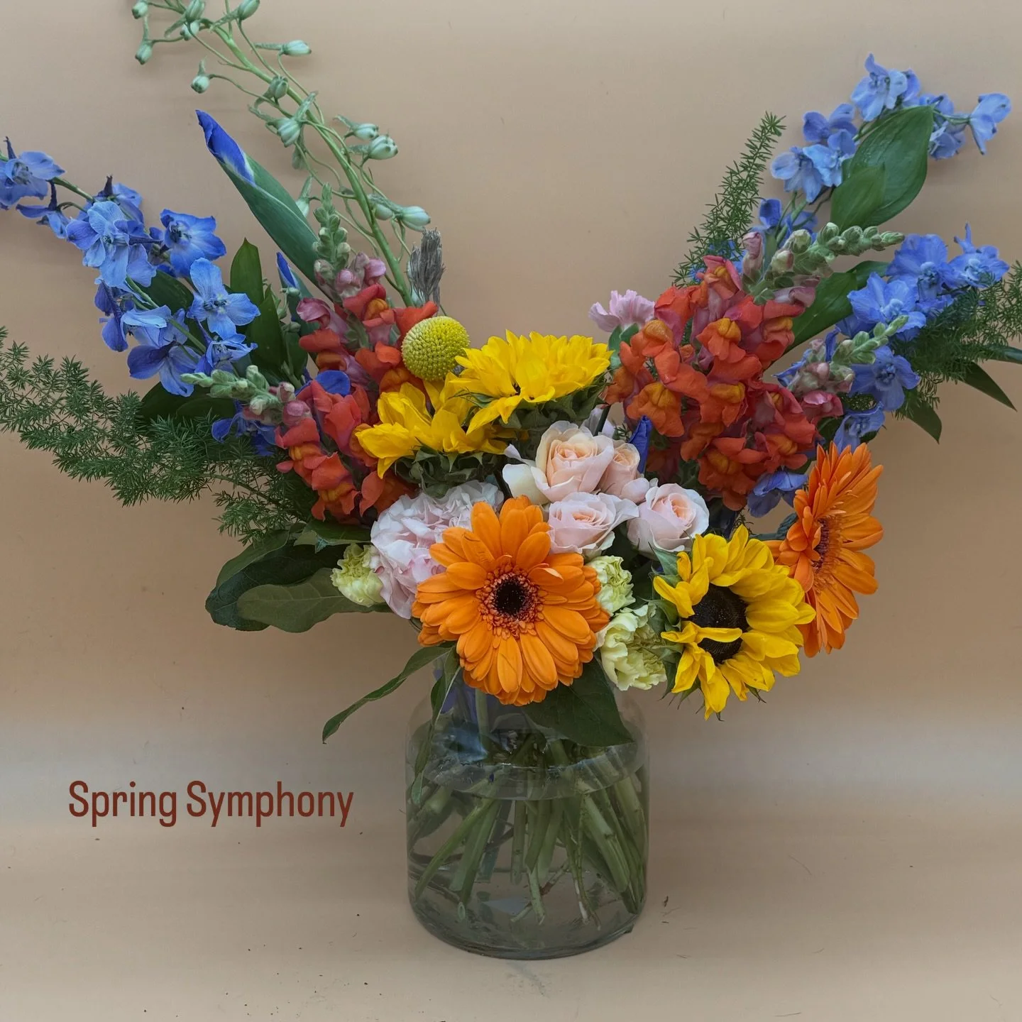 Blue Delphinium, lavender delphinium, orange snaps, Dutch blue Iris, a few roses, a few sunflowers, and the little bit more