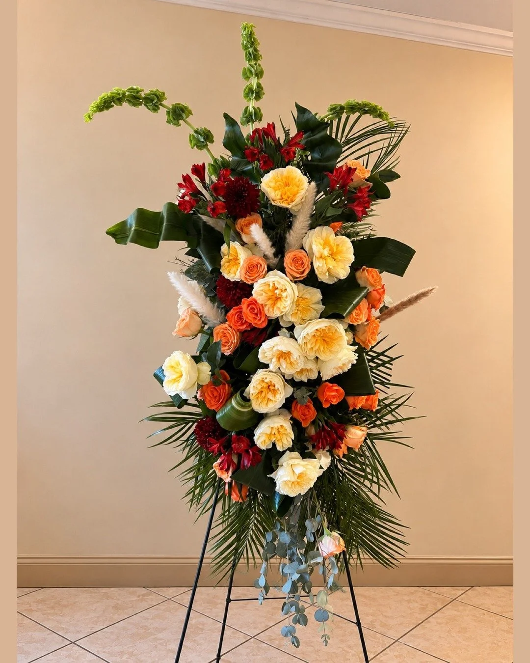 "Different, artistic, beautiful, and larger than life." These were the words friends and family used to describe this unforgettable person.

We translated their words into flowers &mdash; delicate white feathers and folded, twisted aspidist