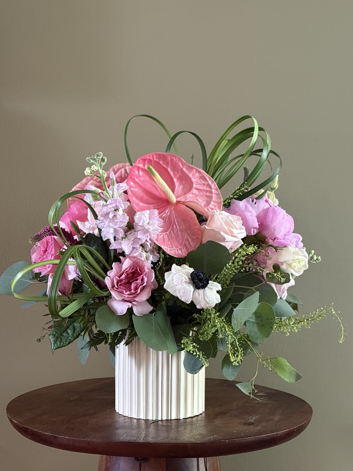 Pink in Motion contemporary floral arrangement with pink anthurium, roses and sculptural bear grass by Gifts of Flowers designed by TA Alexavier-Gof_Designers-choice.PNG
